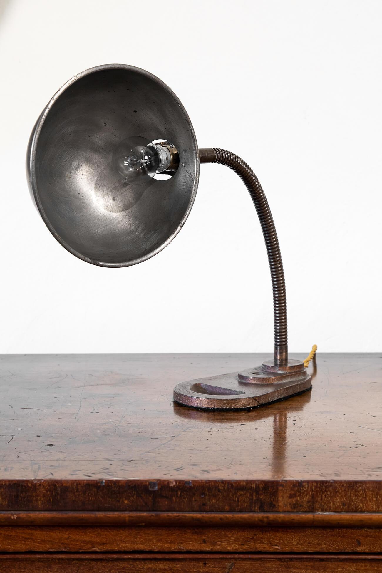 Original gooseneck industrial desk lamp. Cast iron base with flexible gooseneck stem and spun steel shade in its original finish. Twisted three-cord braided fabric cable in gold. The lamp can easily be converted for use in both the USA and