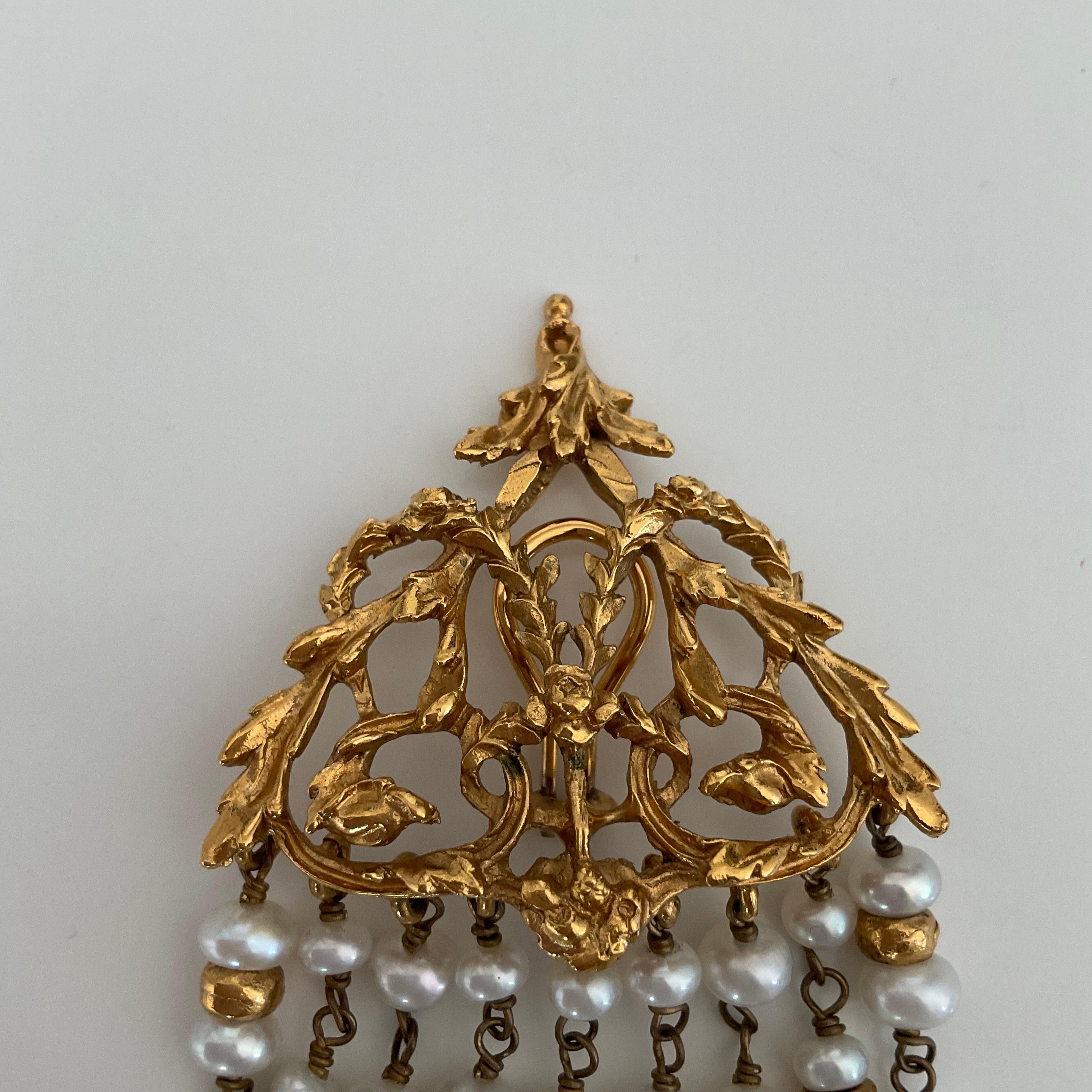 We present you with rare vintage clip-on earrings with natural white pearls. In total, there are nine lines of those white pearls. Feminine and delicate, those chandelier-style earrings are made of 24 carats of gilded bronze from the House of