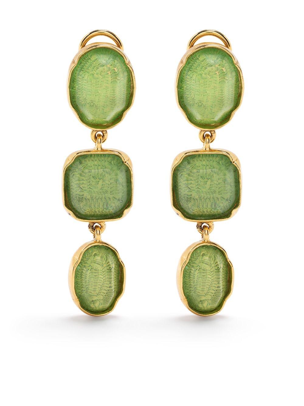 Cabochon triple earrings are bronze soaked in a 24-carat gold bath, yellow gold color, ornate with a lime green tinted rock crystal Cabochon, iconic stone of the Maisin