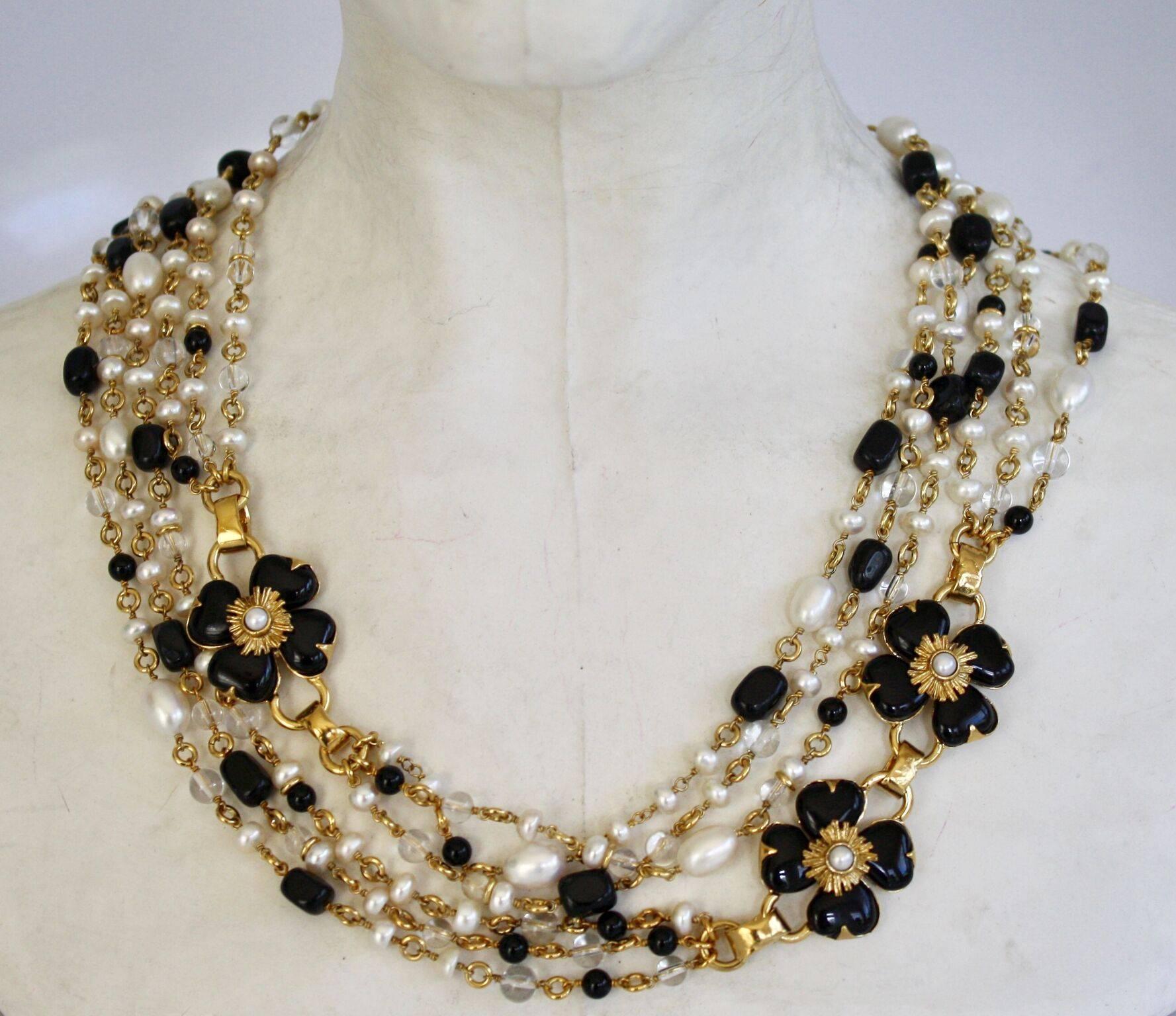 Goossens Paris multi strand necklace of black onyx beads, clear rock crystals, and natural pearls with black onyx clover features. This long necklace can also be doubled or tripled and worn short as a choker. 
