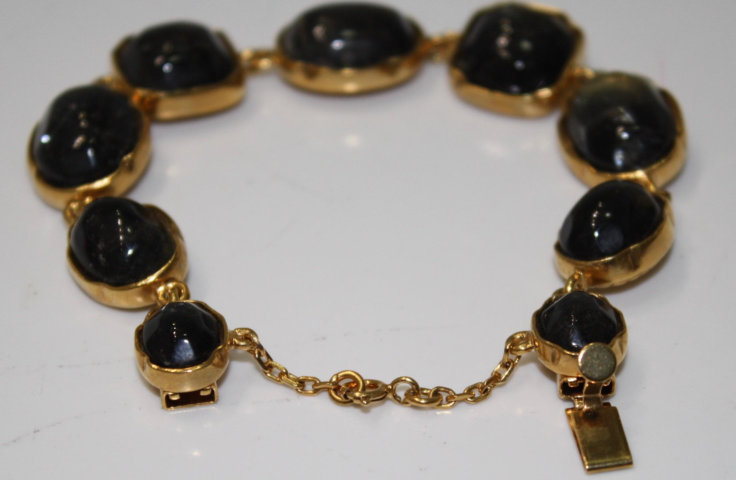 Hand tinted rock crystal in black set on 24Kt gilded bronze. Signature on the back. Security chain.