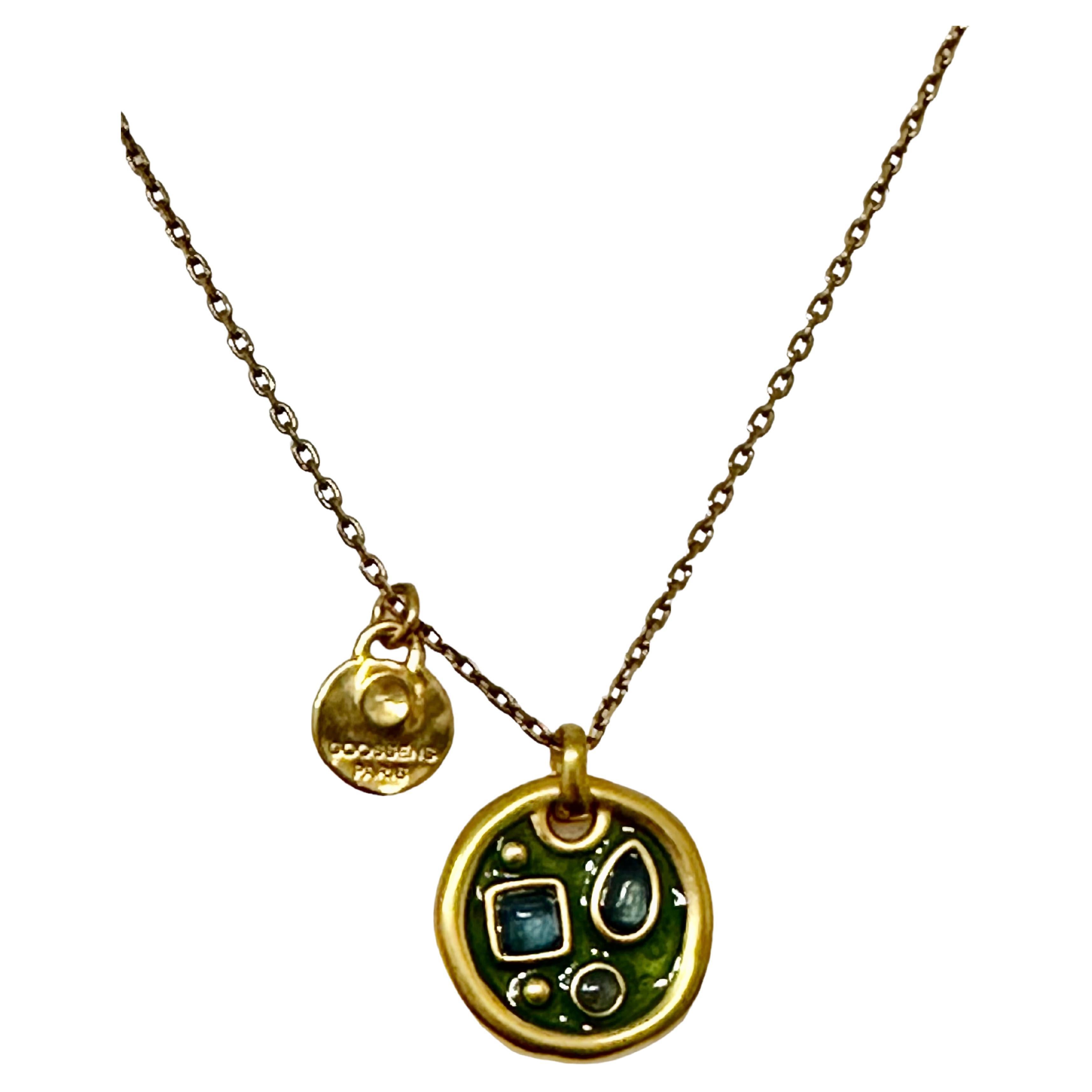 New at the House of Goossens. Pendant necklace from the Boucle Cocktail Collection, revealing a jewel in relief punctuated with rock crystal beads on a patinated enamel. Yellow gold finish. Colour Bicolor Bottle Green

Adjustment chain 2”
Medal