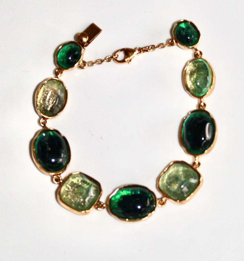 Hand tinted rock crystal in shades of green set on 24Kt gilded bronze. Carved mounting. Signature on the back.
Security chain.