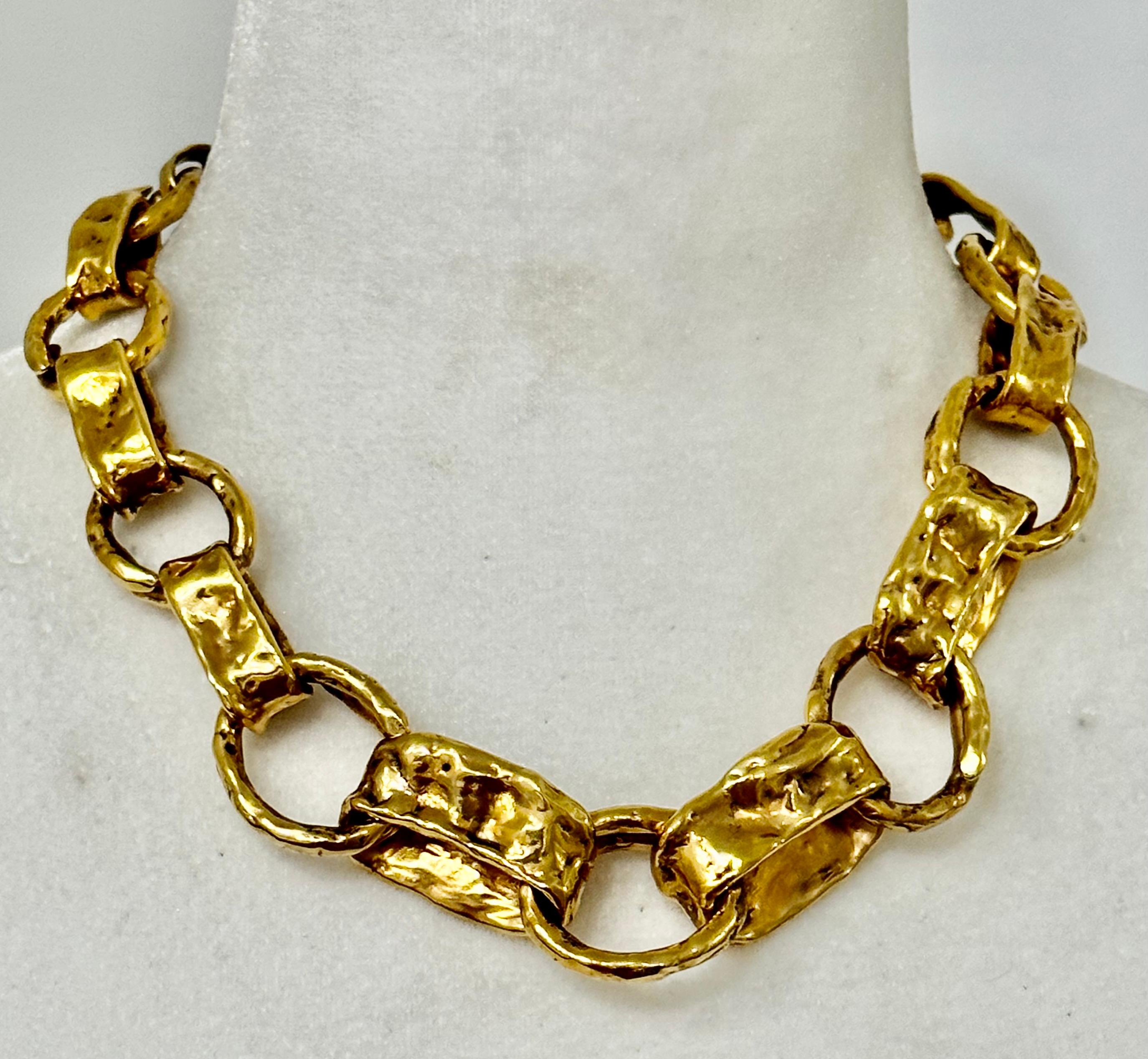 Iconic jewellery by the House of Goossens. Chain necklace from the Lutece  collection featuring surprisingly light oval and textured links. Yellow gold finish. A striking piece, to be worn alone or with other Goossens jewellery.
24-carat gilded Brass