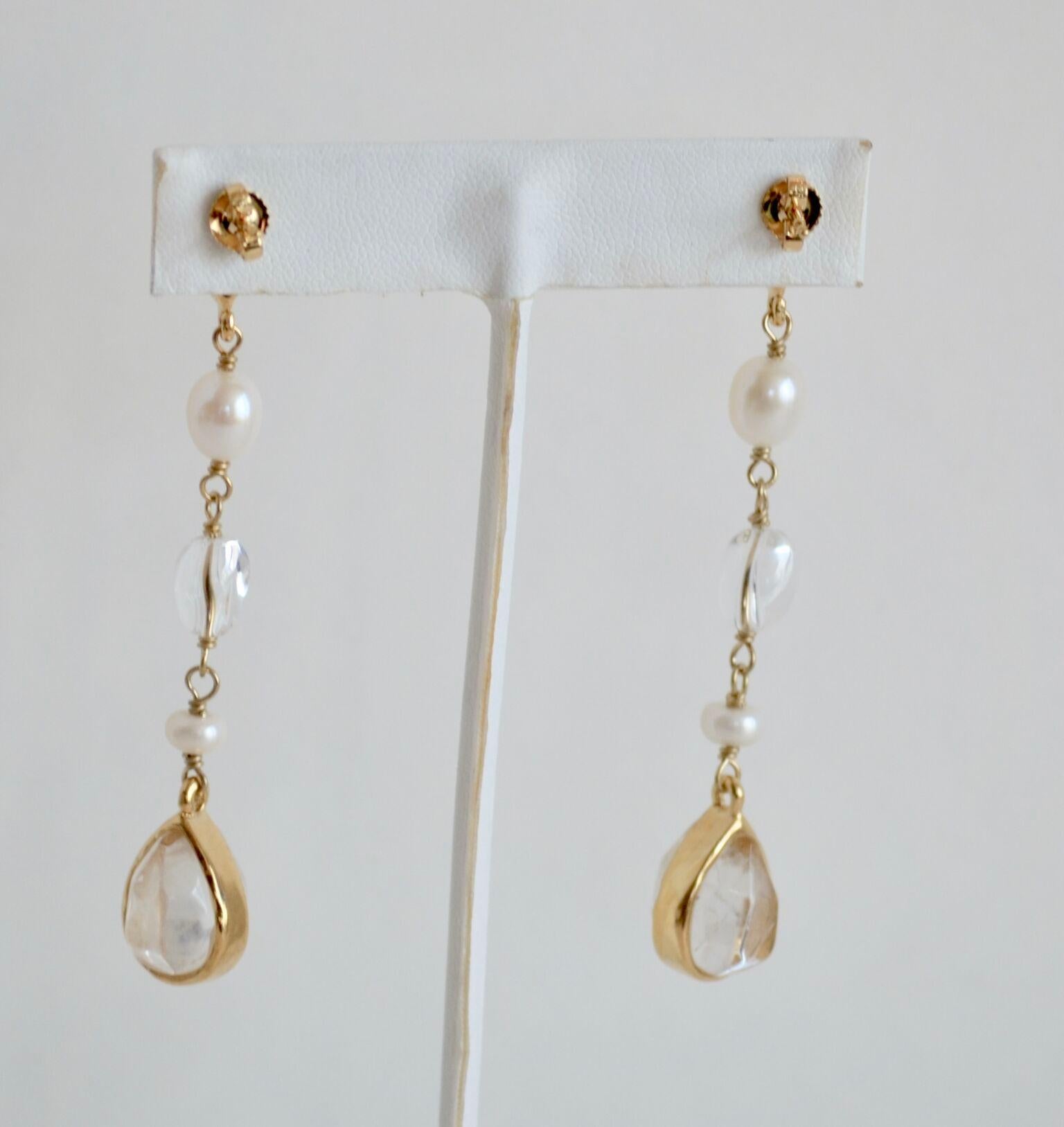 Pierced earrings made with 24-karat gold plated brass, natural pear-shaped rock crystal stones and freshwater pearls.

All the stones are cut by hand for the House of Goossens.
