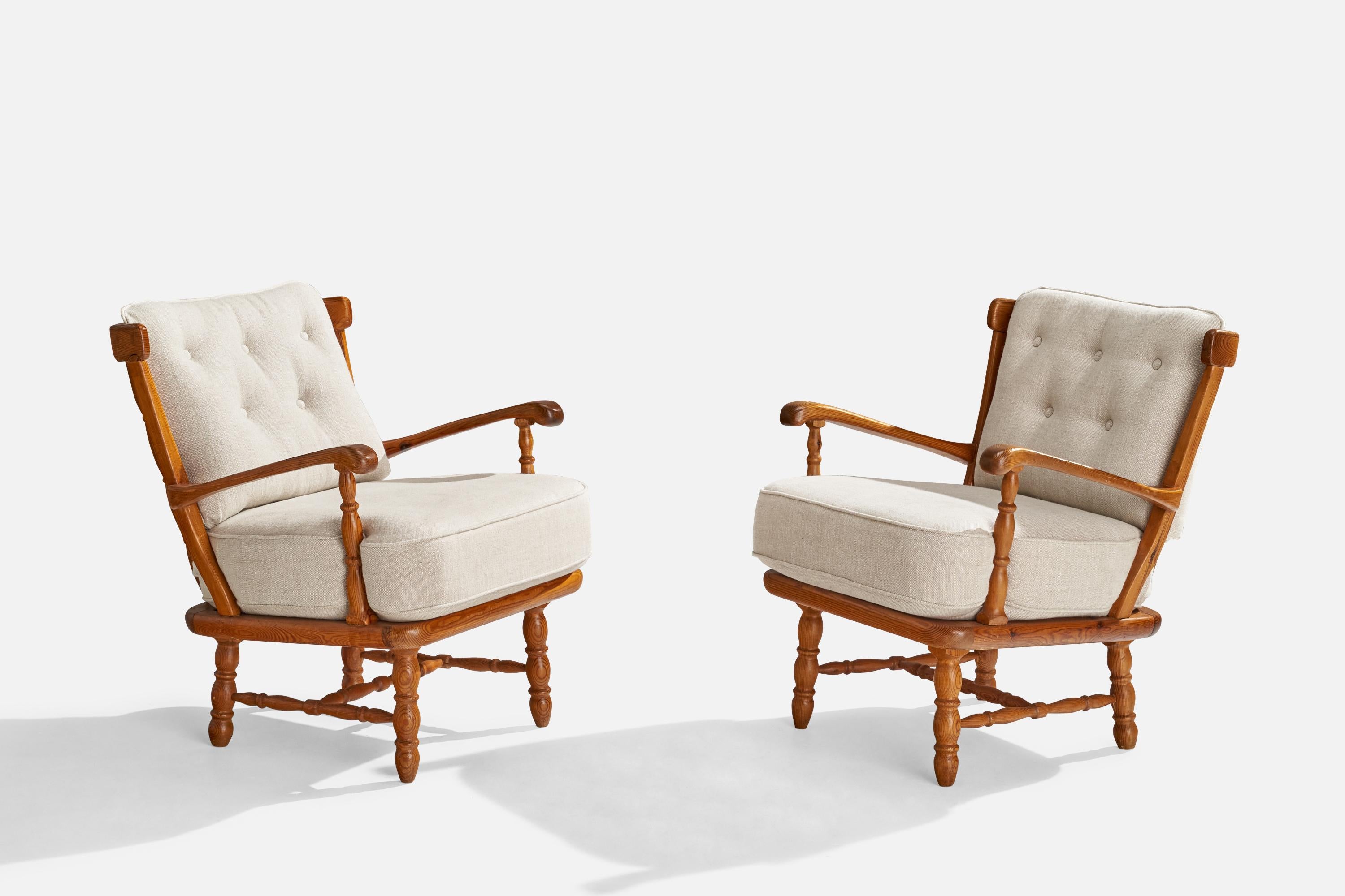 A pair of pine and white fabric lounge chairs produced by Göperts, Sweden, c. 1950s.

Seat height: 19”