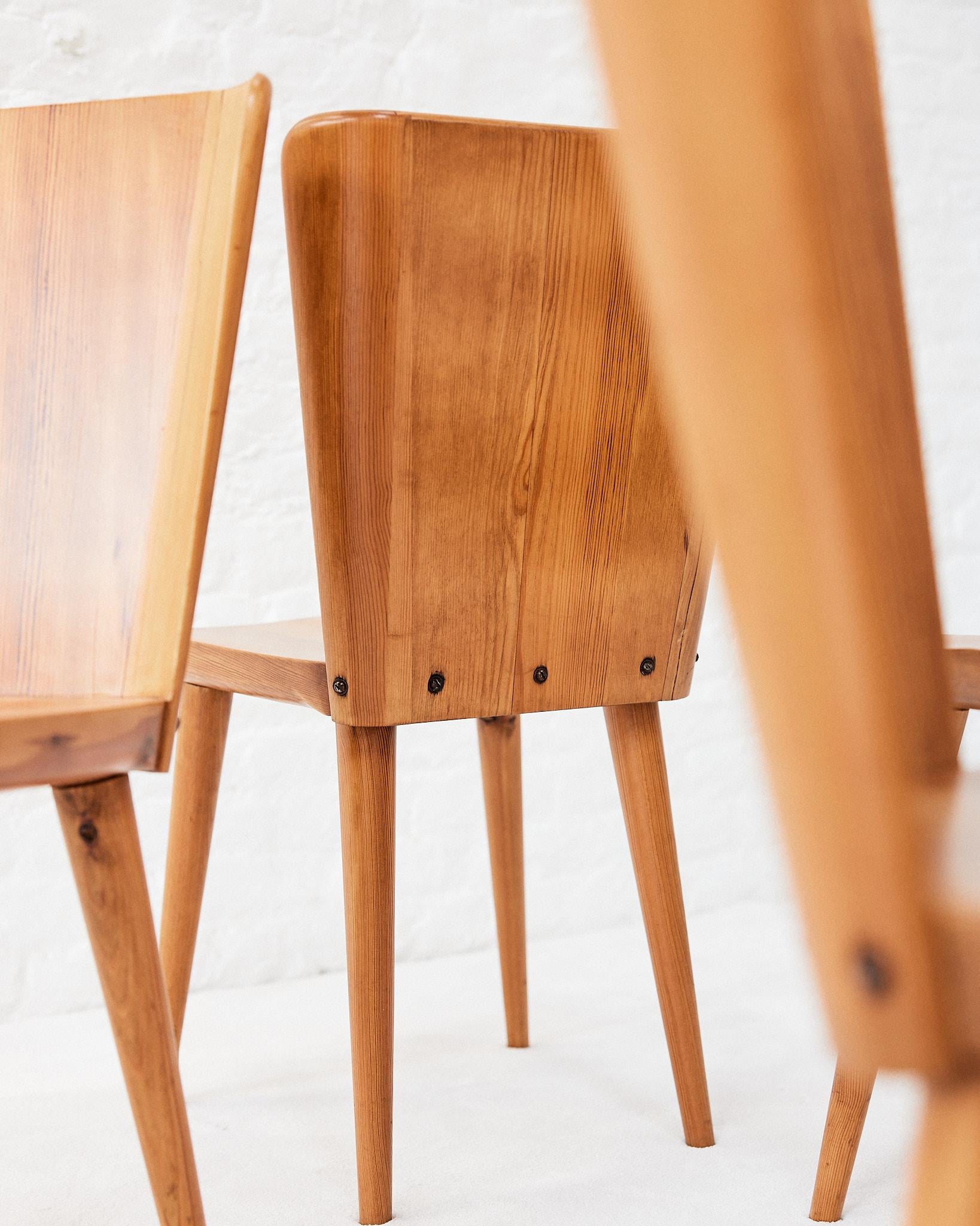 Chairs designed by Goran Malmvall for Karl Anderson & Soner, in the 1950s, with a solid pine seat and base. The backrests run wide near the highest and consist of straight and slightly curved near the ends.
The Swedish dining chairs hold a powerful