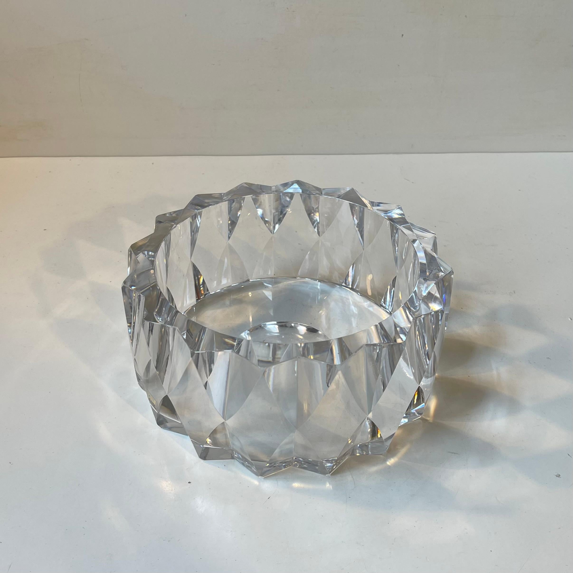 A massive centerpiece bowl in cut crystal. Very sculptural: multi-faceted, thick edges and very heavy. Designed by the iconic Swedish glass wizard Göran Wärff during the 1980s. Its hand-signed to its base by the artist and maker. Sticker from Kosta