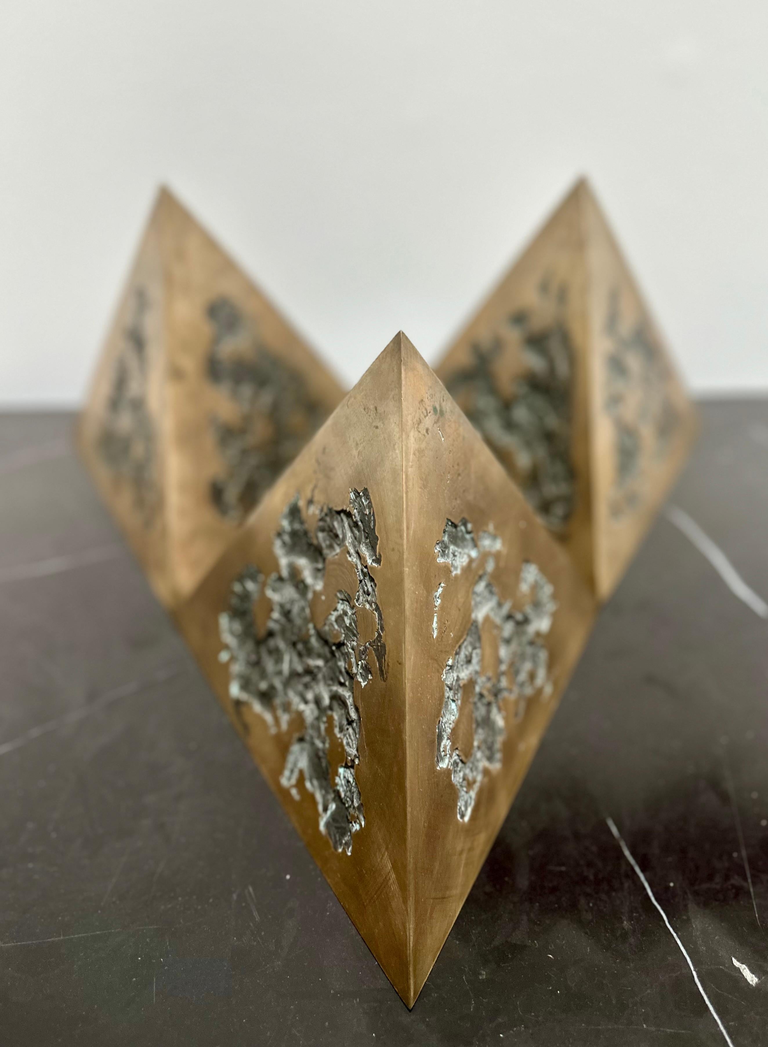 Three identically-shaped bronze triangular prisms comprise this unique work by renowned Canadian sculptor, Gord Smith (1937-2023). The individual pieces are meant to be moved to create different formations, seen as a triptych. 
