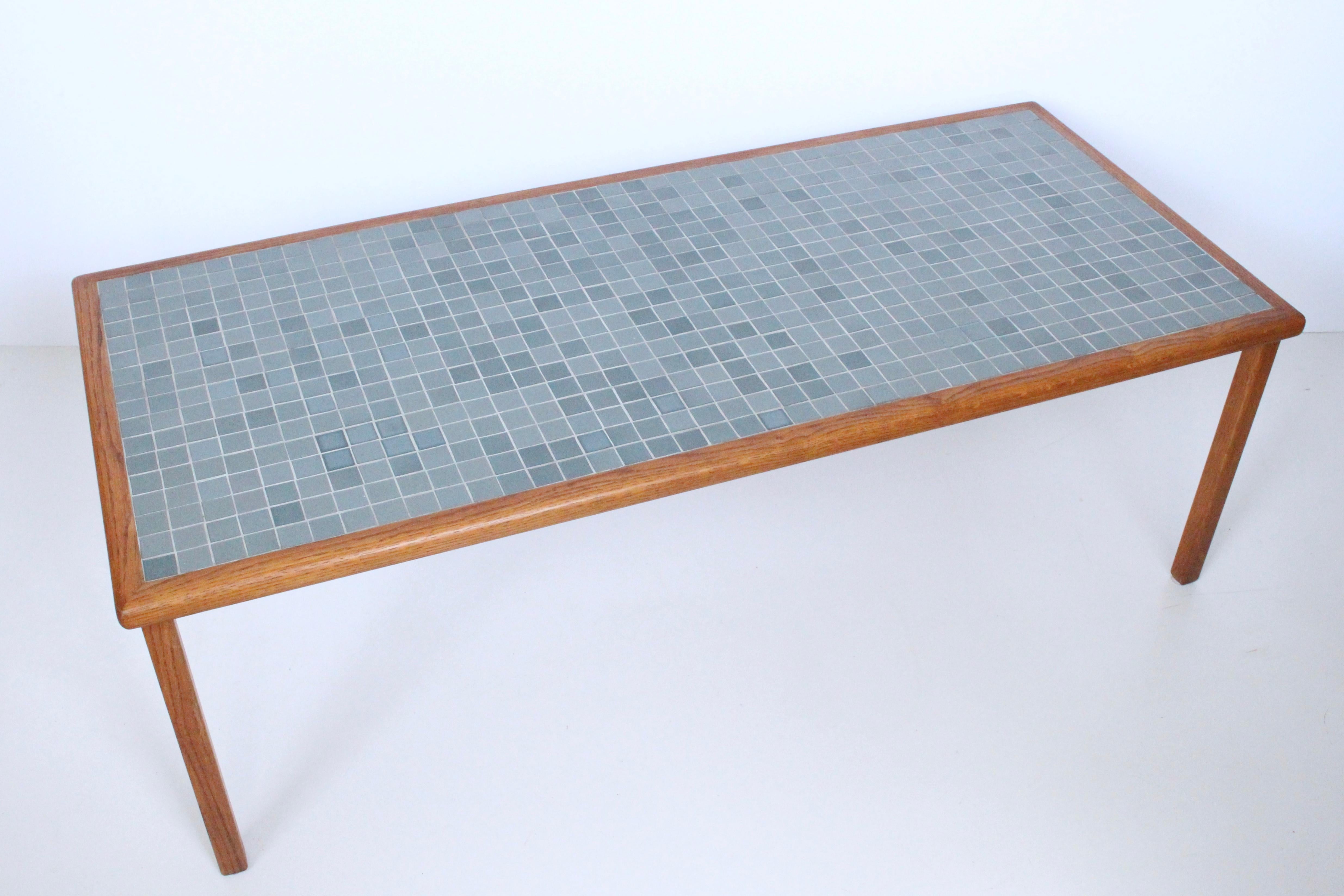 American Mid-Century Modern Jane and Gordon Martz teal tile top table, 1950s. Featuring a larger rectangular braced Oak framework atop square Oak legs, inset with a variegated Teal toned matte glazed stoneware tile pattern. Desirable teal color and