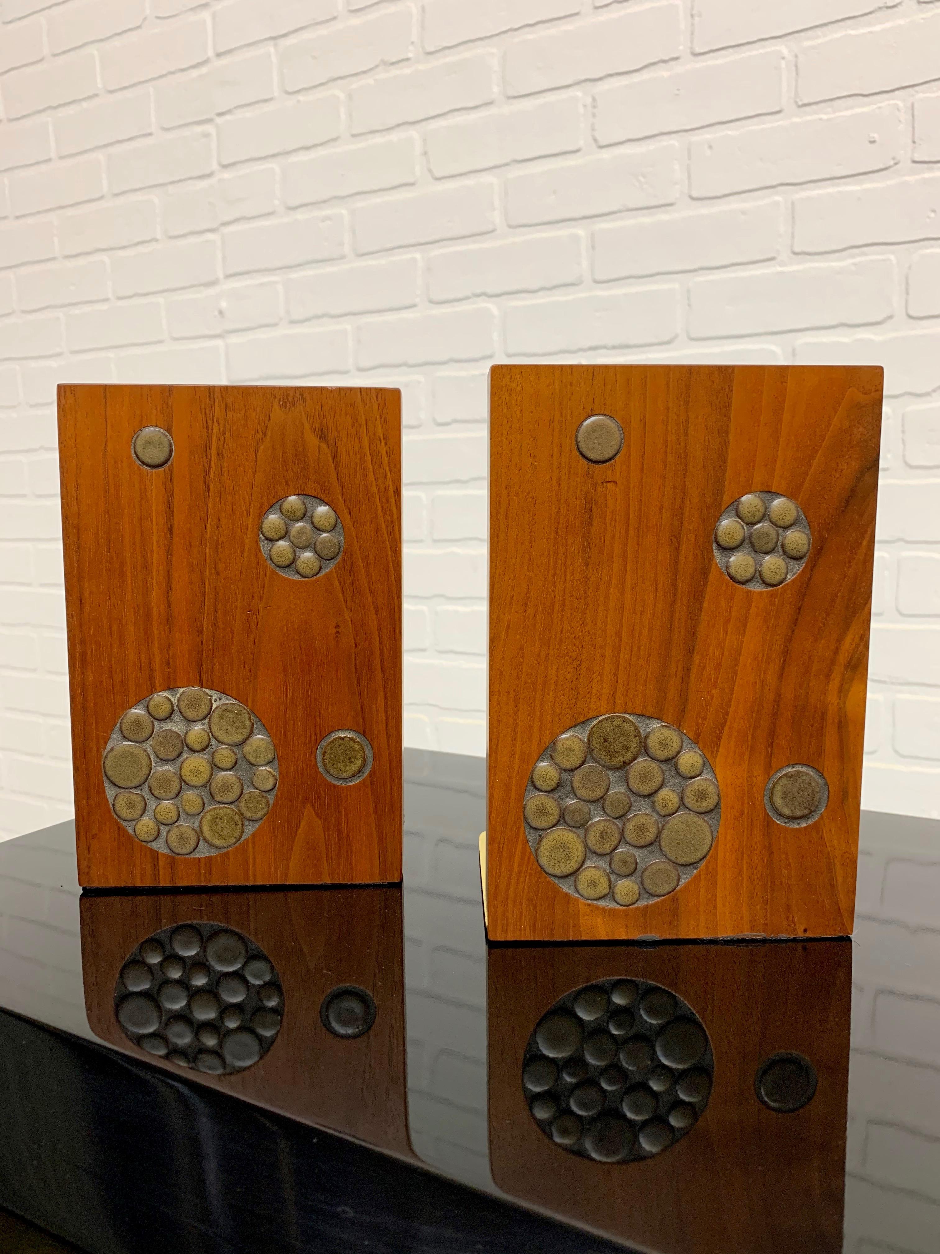 Solid walnut with circular inlaid tiles make for a stunning pair of bookends.