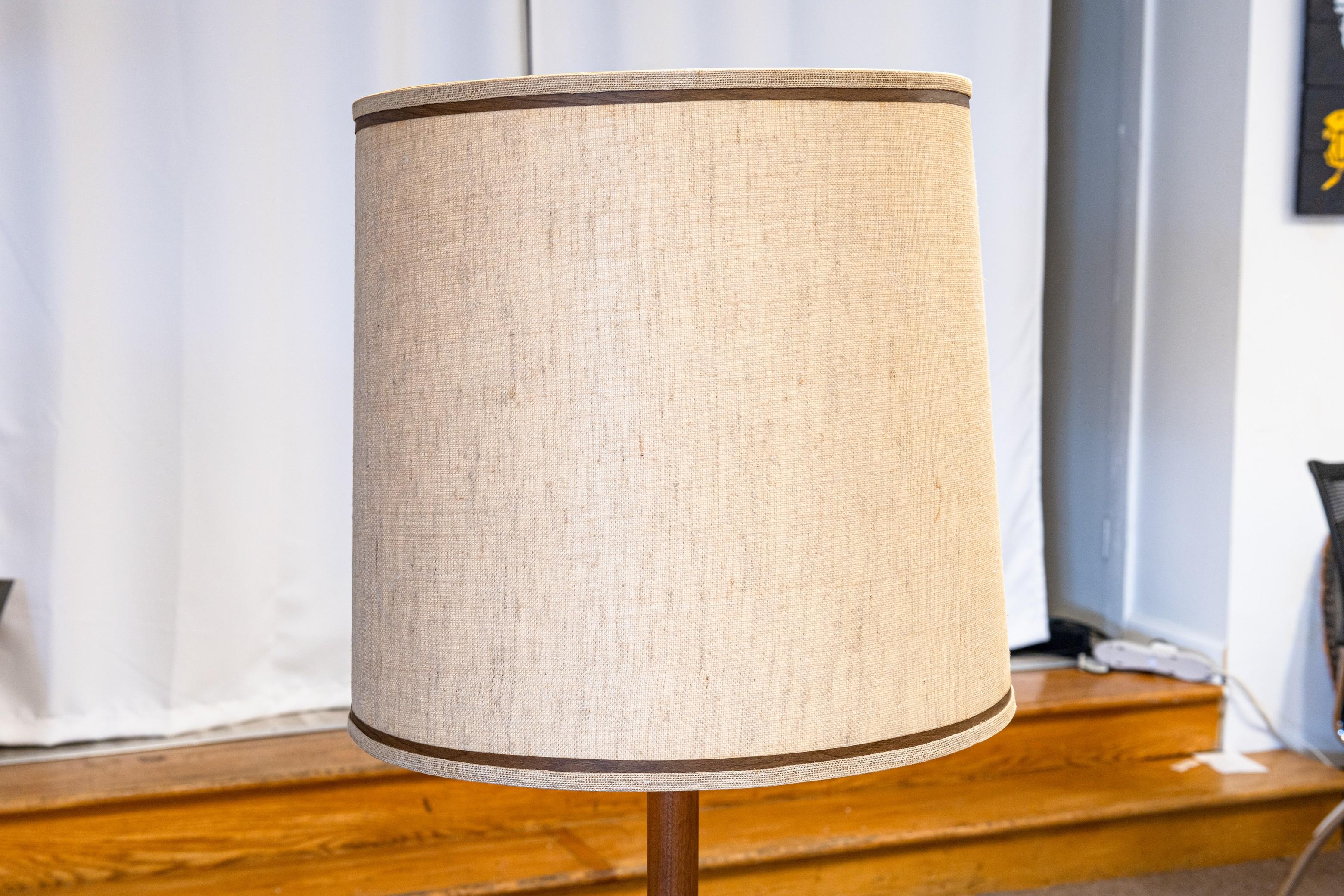 A beautiful floor lamp from Gordon and Jane Martz for Marshall Studios. This lovely floor lamp features an iconic tile table design, with a grey/blue colored circular tile pattern. The whole floor lamp is made of a beautiful teak wood. The shade is