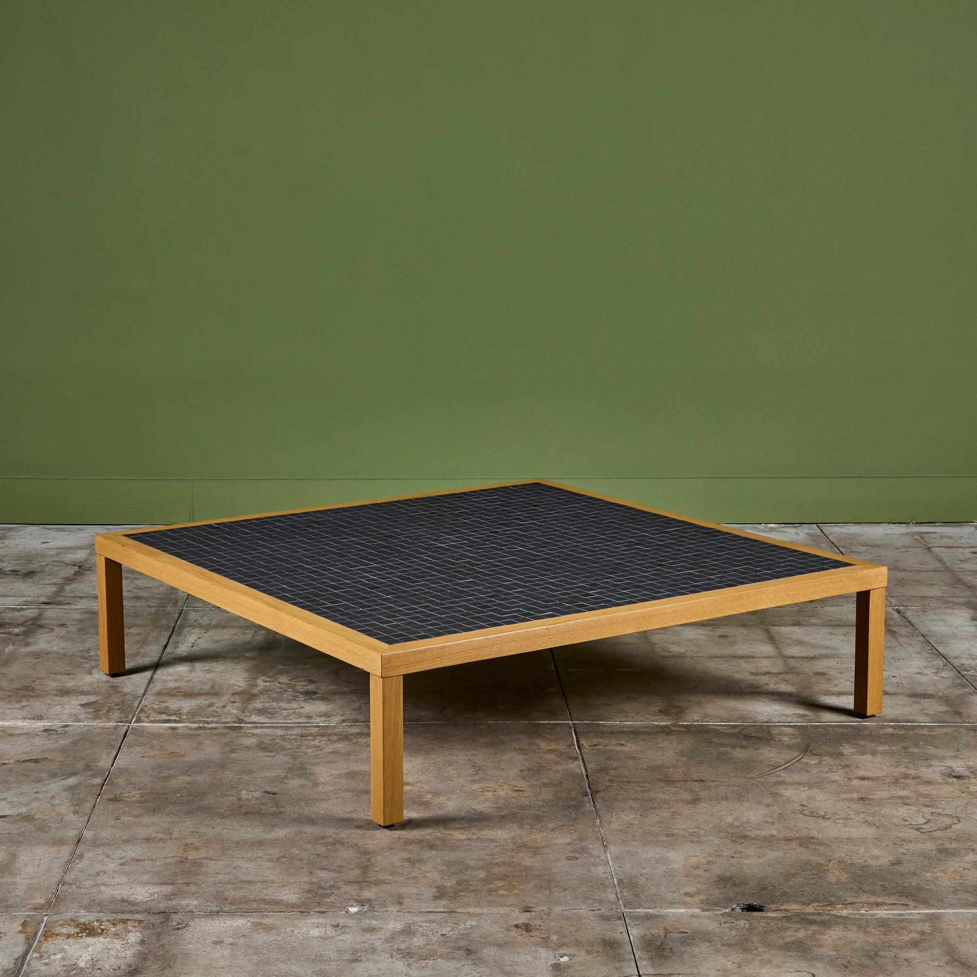 Square coffee table by Gordon & Jane Martz. The table top is inlaid with black square ceramic tiles. The frame of the table and four legs are solid oak.
 
Dimensions
48.5