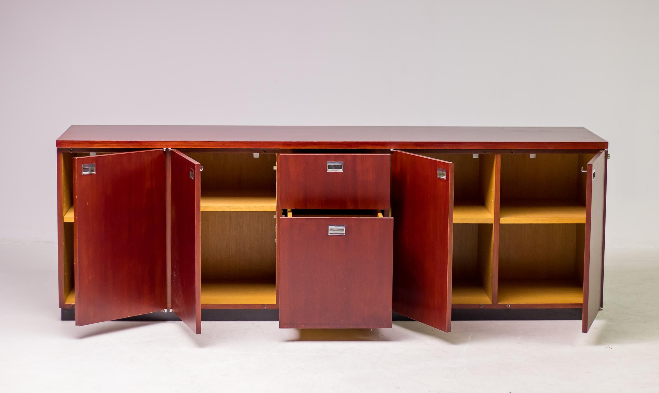 Mahogany credenza with chrome recessed pulls, designed by Gordon Bunschaft and manufactured by De Coene for the Belgium Lambert Bank, circa 1960. The credenza features seven drawers with a lock on the side. The piece is finished on all sides so it