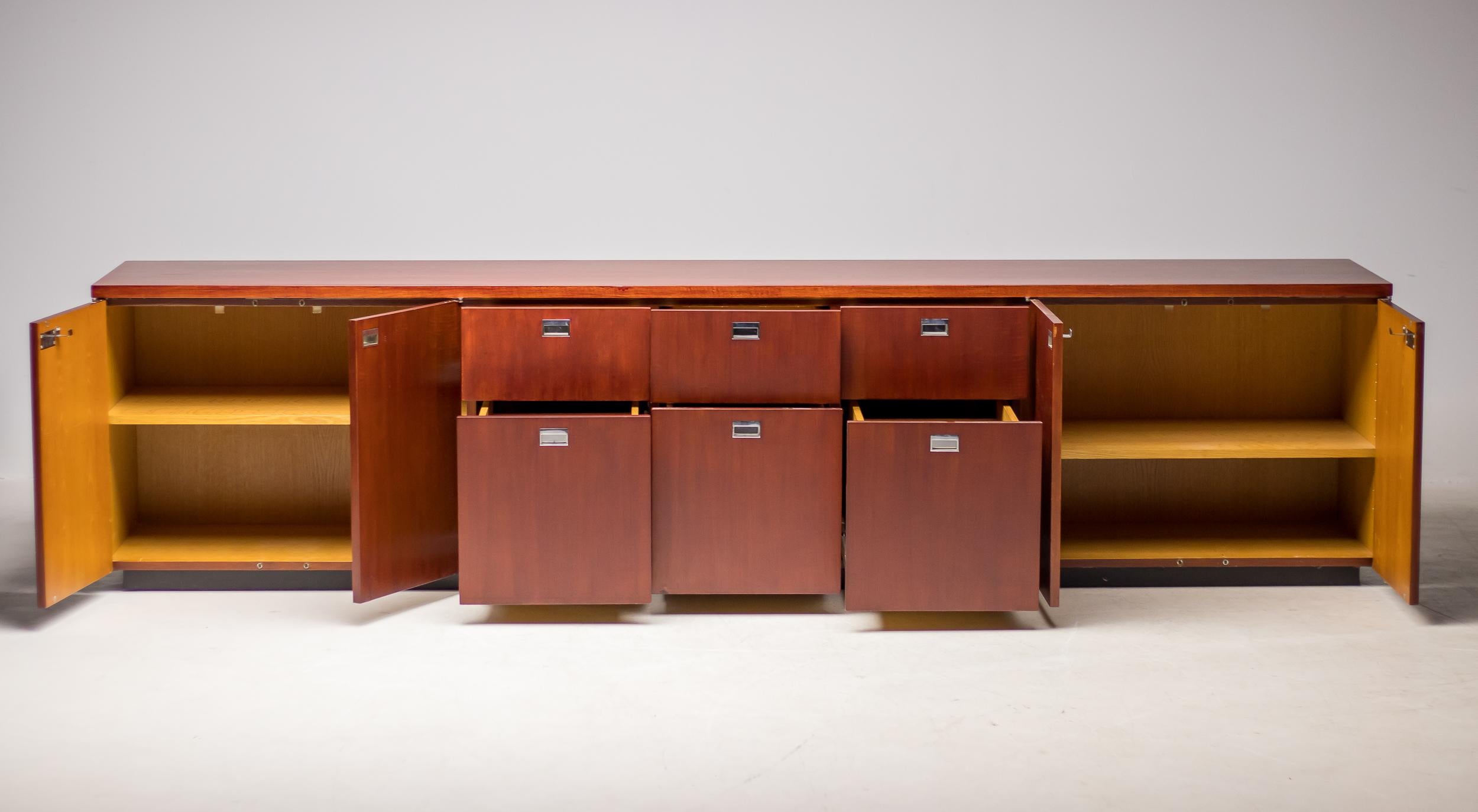Large mahogany credenza with chrome recessed pulls, designed by Gordon Bunschaft and manufactured by De Coene for the Belgium Lambert Bank, circa 1960. The credenza features six drawers and four doors with a lock on both sides. The piece is finished