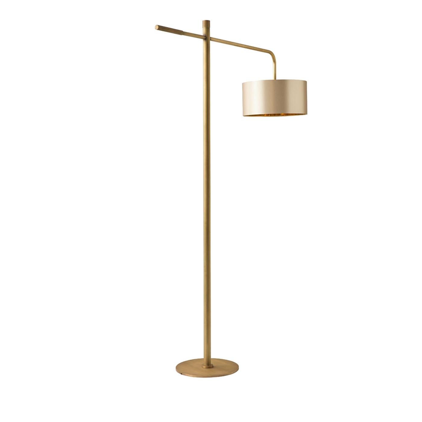 A traditional style gets a chic contemporary makeover in the Gordon floor lamp. On a round, Minimalist base, the floor lamp with a burnished brass finish features a decorative knurled insert and a round drum shade. Thanks to its long arm and