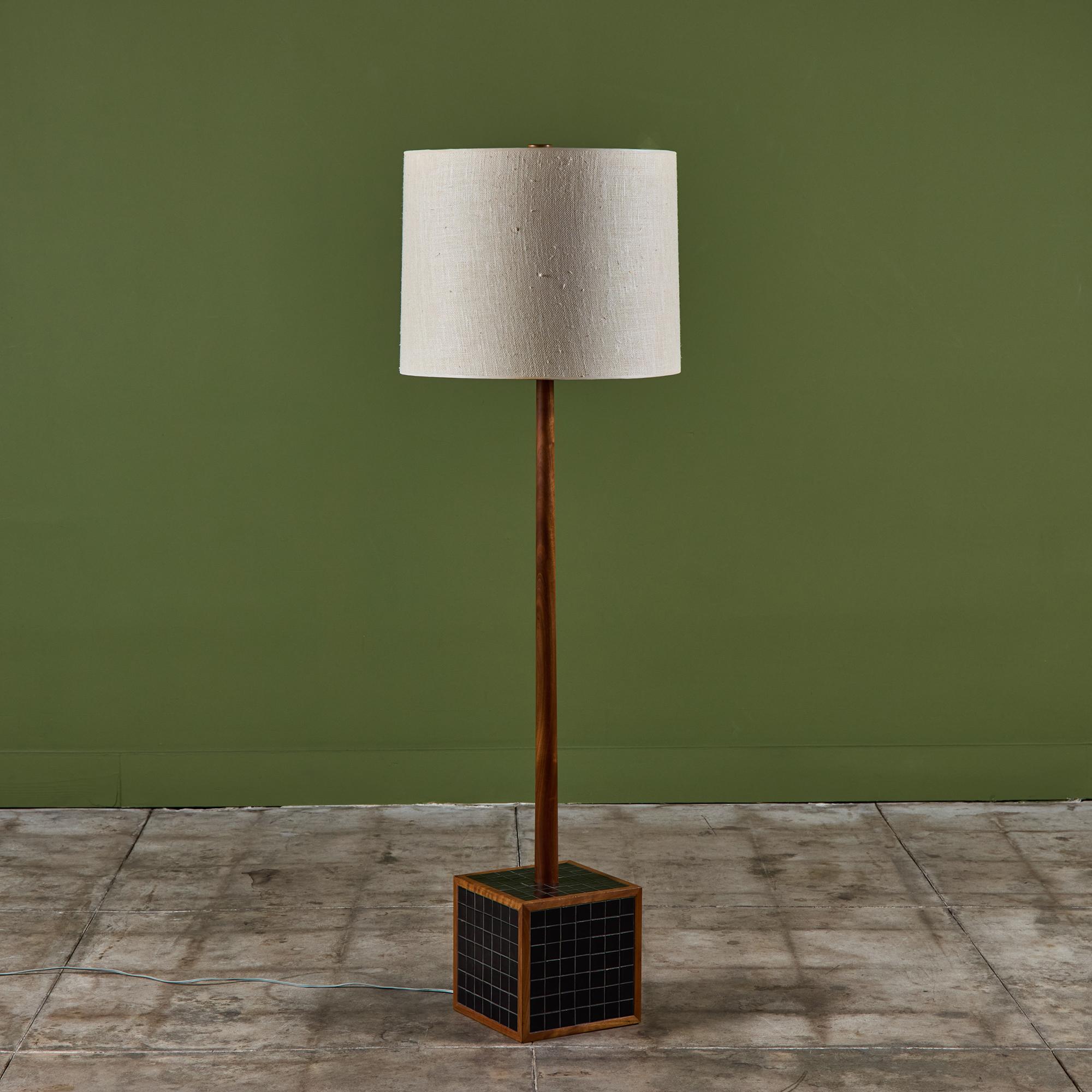 Gordon & Jane Martz block floor lamp with tile inlay. This piece features a walnut stem with inlaid black square tiles on a cube base. The lamp has a newly made linen shade and new wiring.

Dimensions
19
