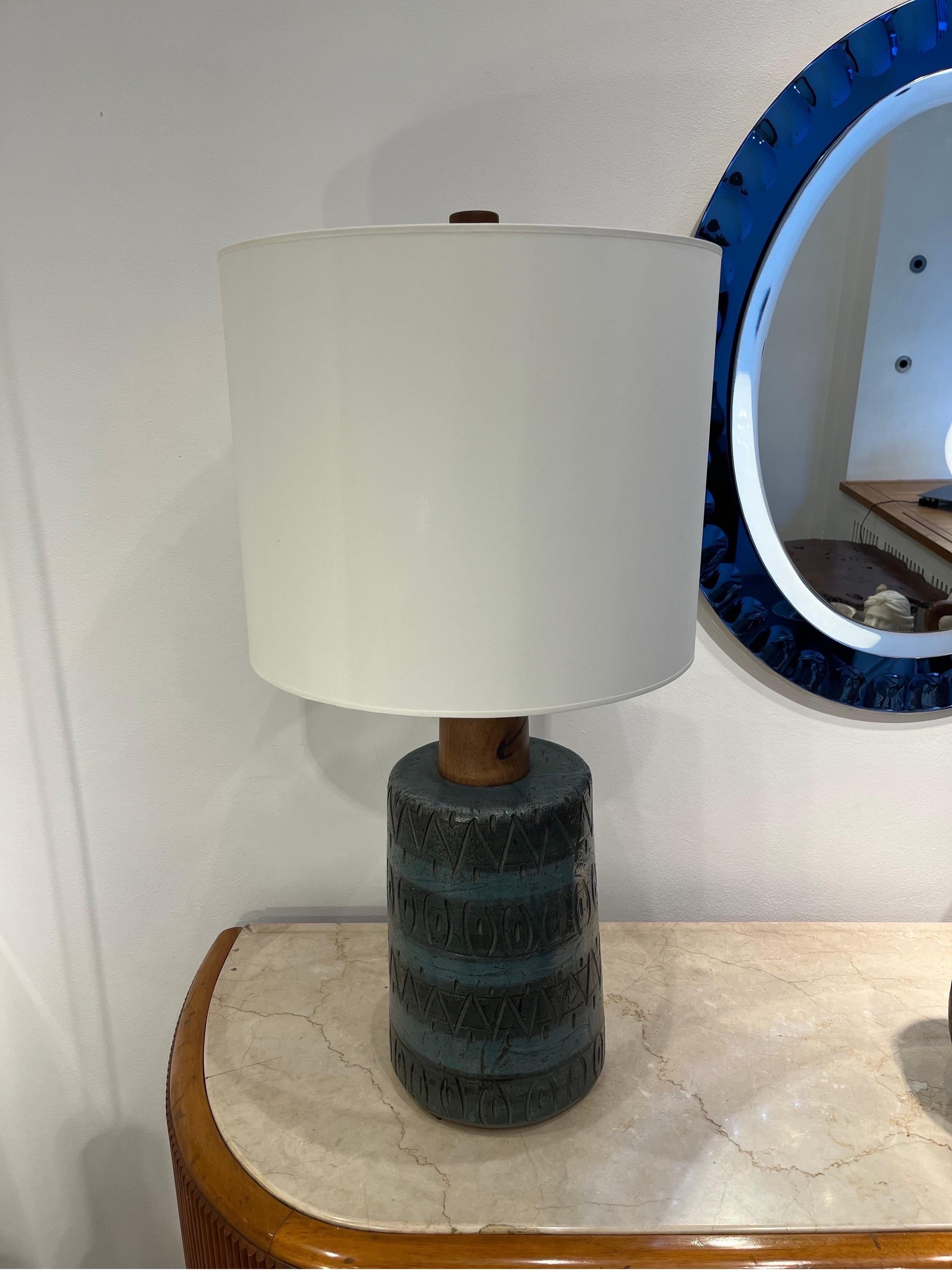 Ceramic table lamp created by Gordon & Jane Marta in the 1960s and produced in the Marshall Studios, Indianapolis. Decorated with a geometric abstract pattern colored in dark and lighter blue. The use of walnut for the shade holder is typical of
