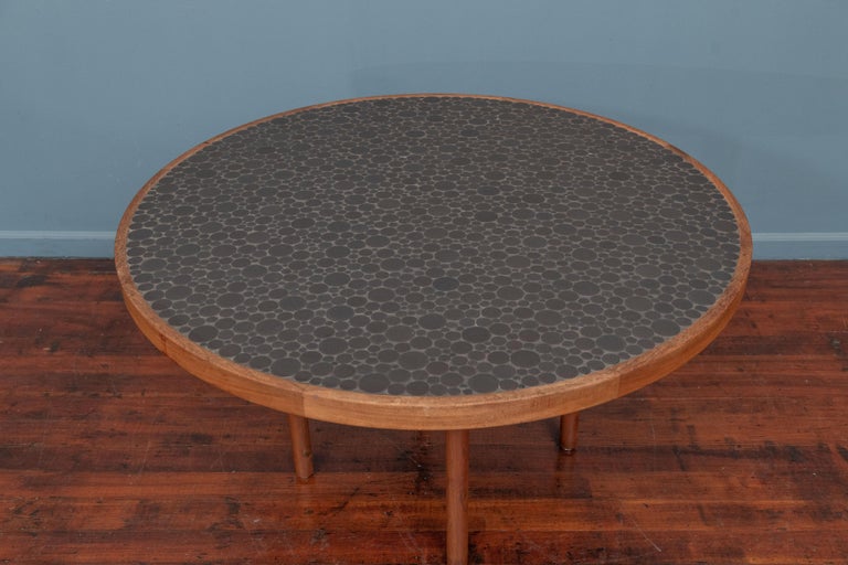Gordon & Jane Martz coin tile games or center table for Marshall Studios.
 Rare configuration with the highly desirable flat black ceramic coin tile top with a walnut banded edge on rounded legs.