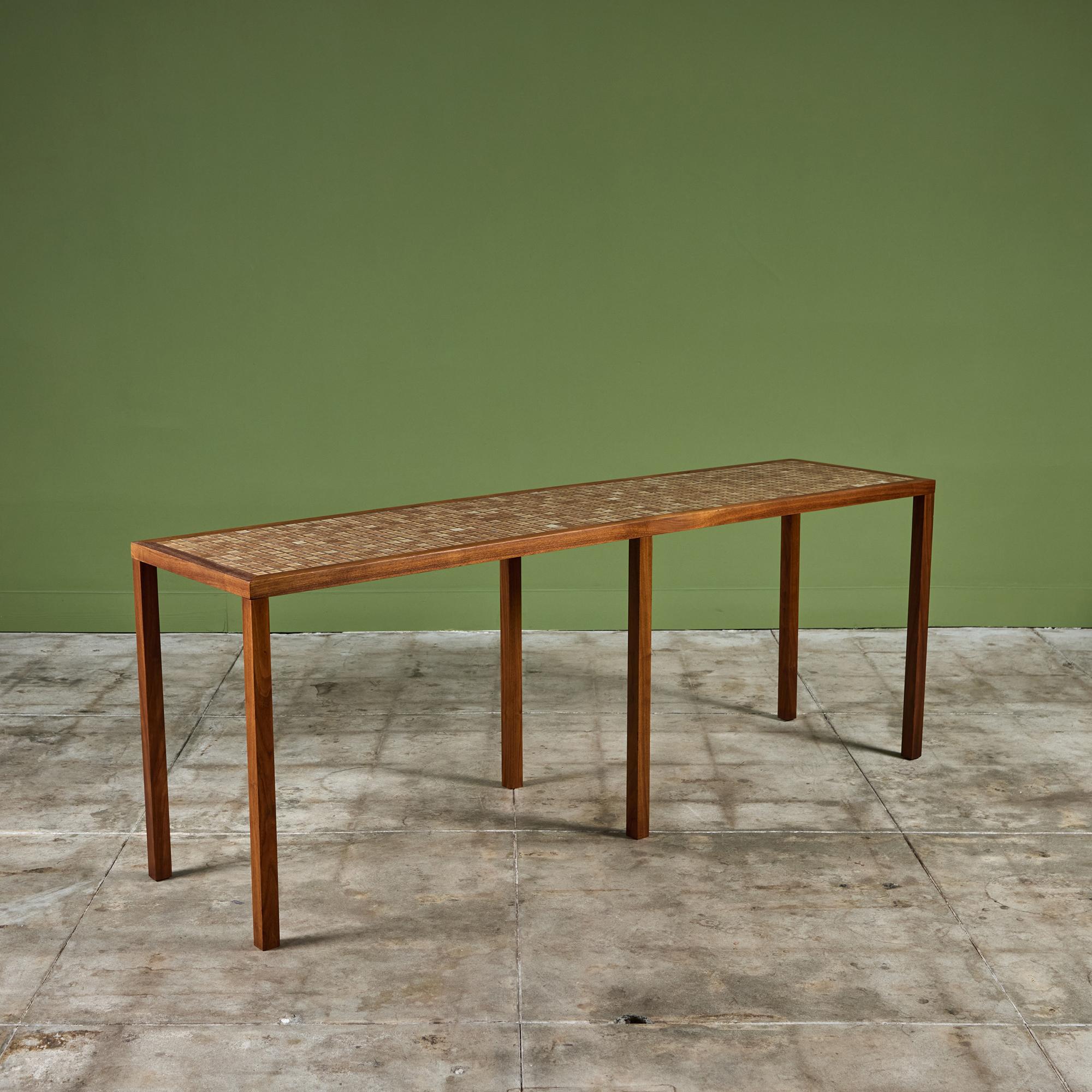 Console table by Gordon & Jane Martz. The table top is inlaid with square ceramic tiles in cream and warm brown tones. The frame of the table and six legs are solid oak.

Dimensions 
80.75
