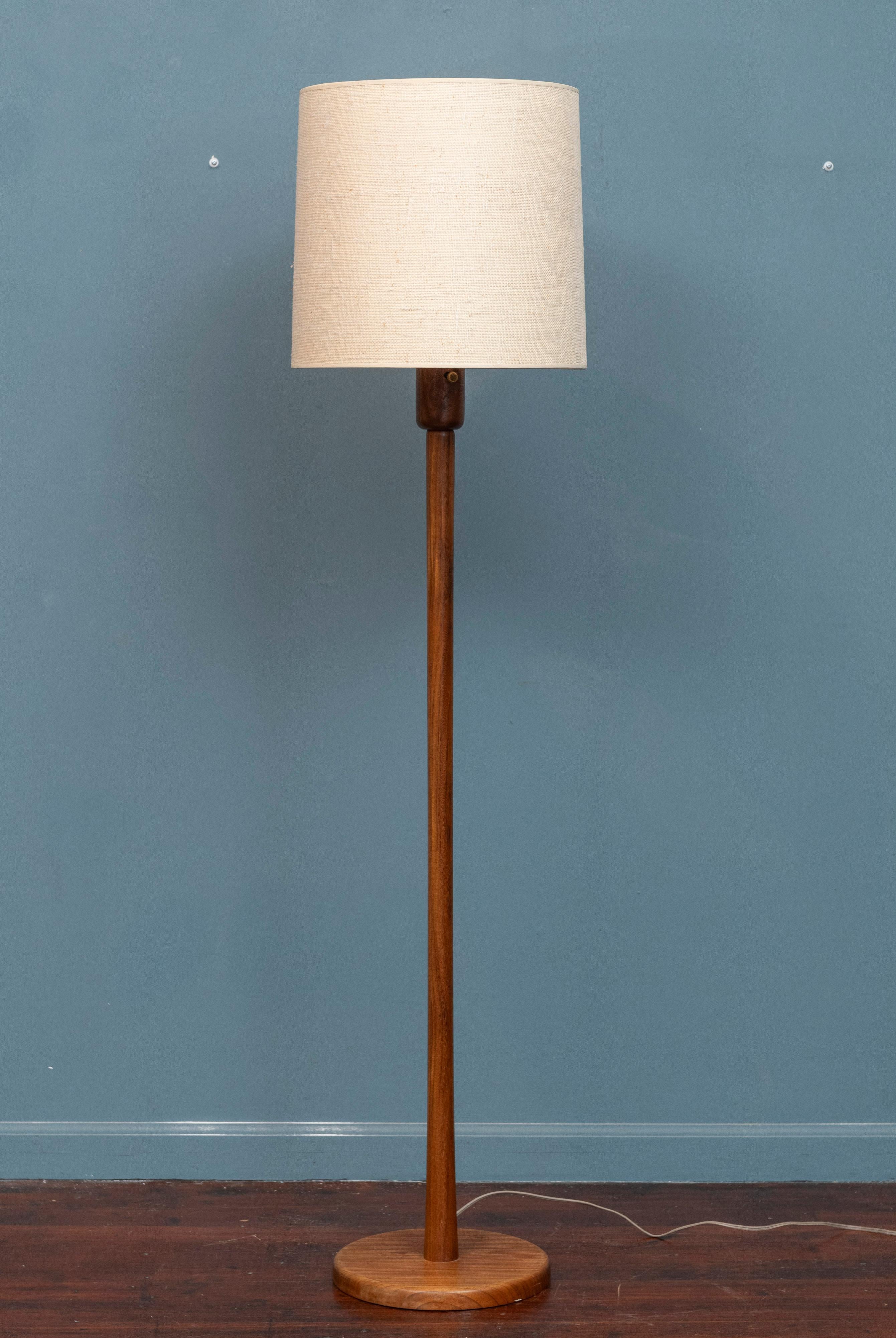Gordon & Jane Martz design floor lamp. High quality construction and use of materials by the husband and wife design couple. Beautiful sculpted walnut body with tapering in diameter throughout and a weighted base for stability. Super simple but