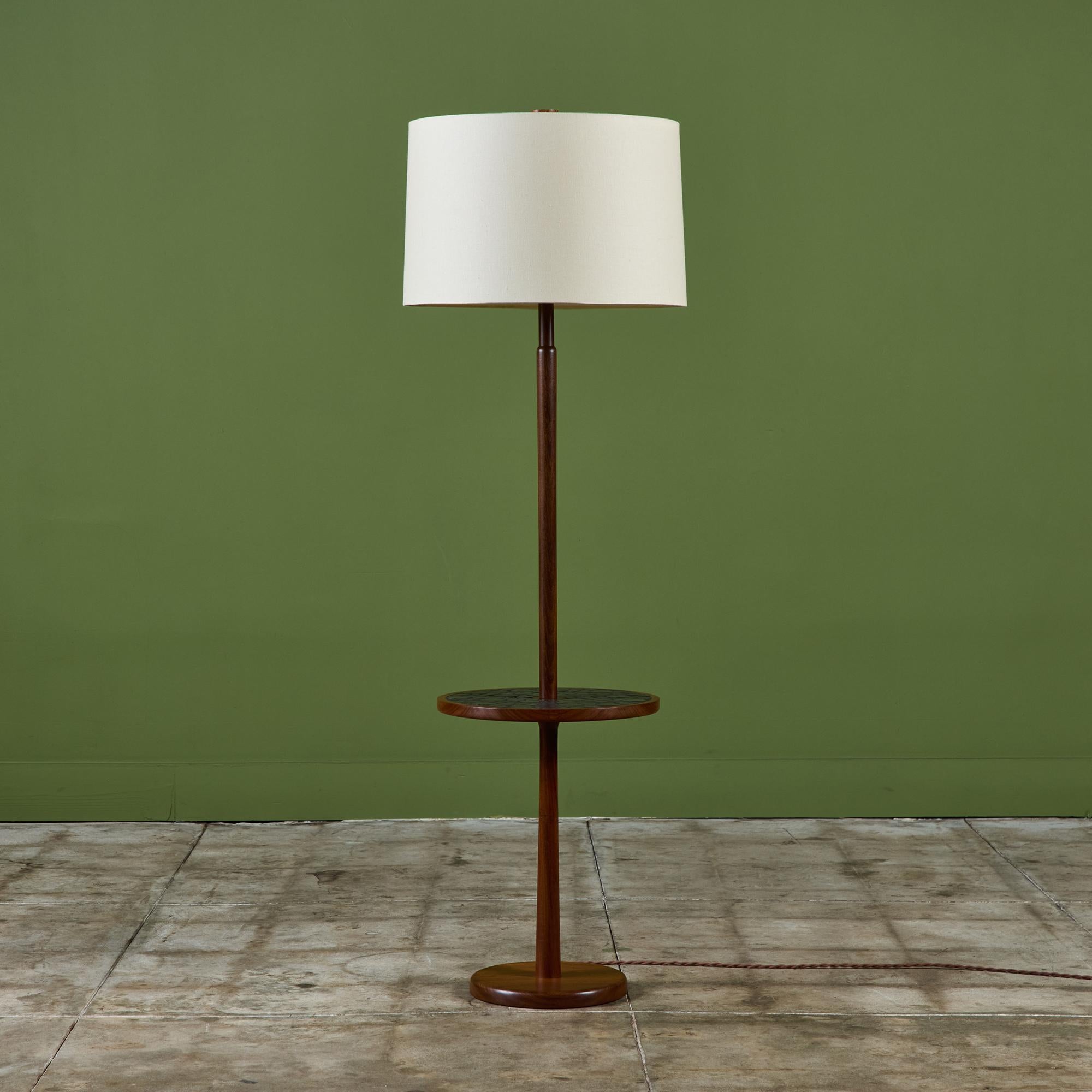 Gordon & Jane Martz floor lamp with mosaic tile round side table. This piece features a walnut base with inlaid black ceramic coin tiles on the table top. The lamp has a newly made linen shade and new wiring.

Dimensions
16