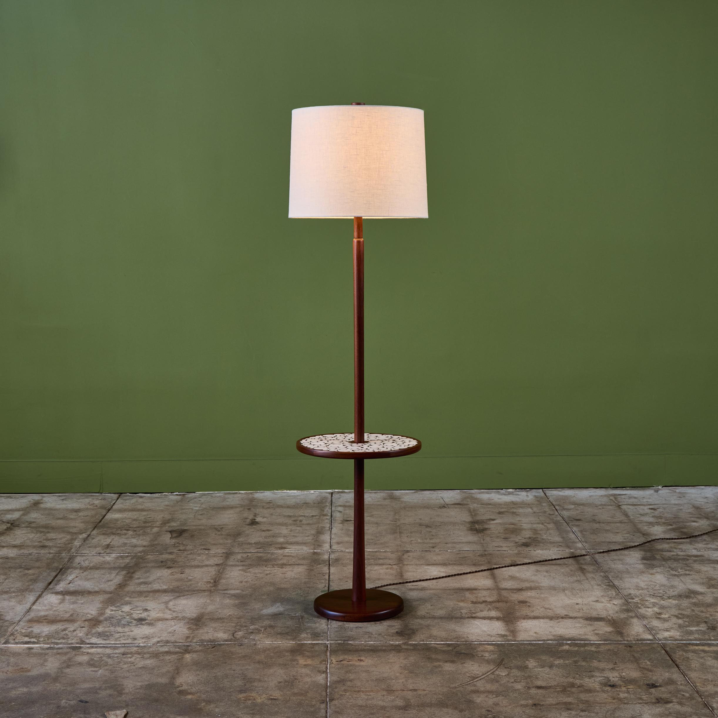 Gordon & Jane Martz floor lamp with mosaic tile round side table. This piece features a walnut base with inlaid white ceramic coin tiles on the table top. The lamp has a newly made linen shade and new wiring.

Dimensions
16