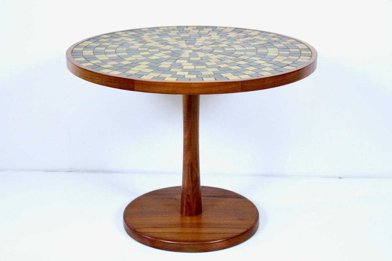 Jane & Gordon Martz for Marshall Studios Walnut & Tile TOI-28 Occasional Table. Featuring a round Walnut frame, and weighted base, 20H tulip shaped pedestal column with natural, neutral toned Dark Olive Green and Pale Mustard square ceramic tiles.