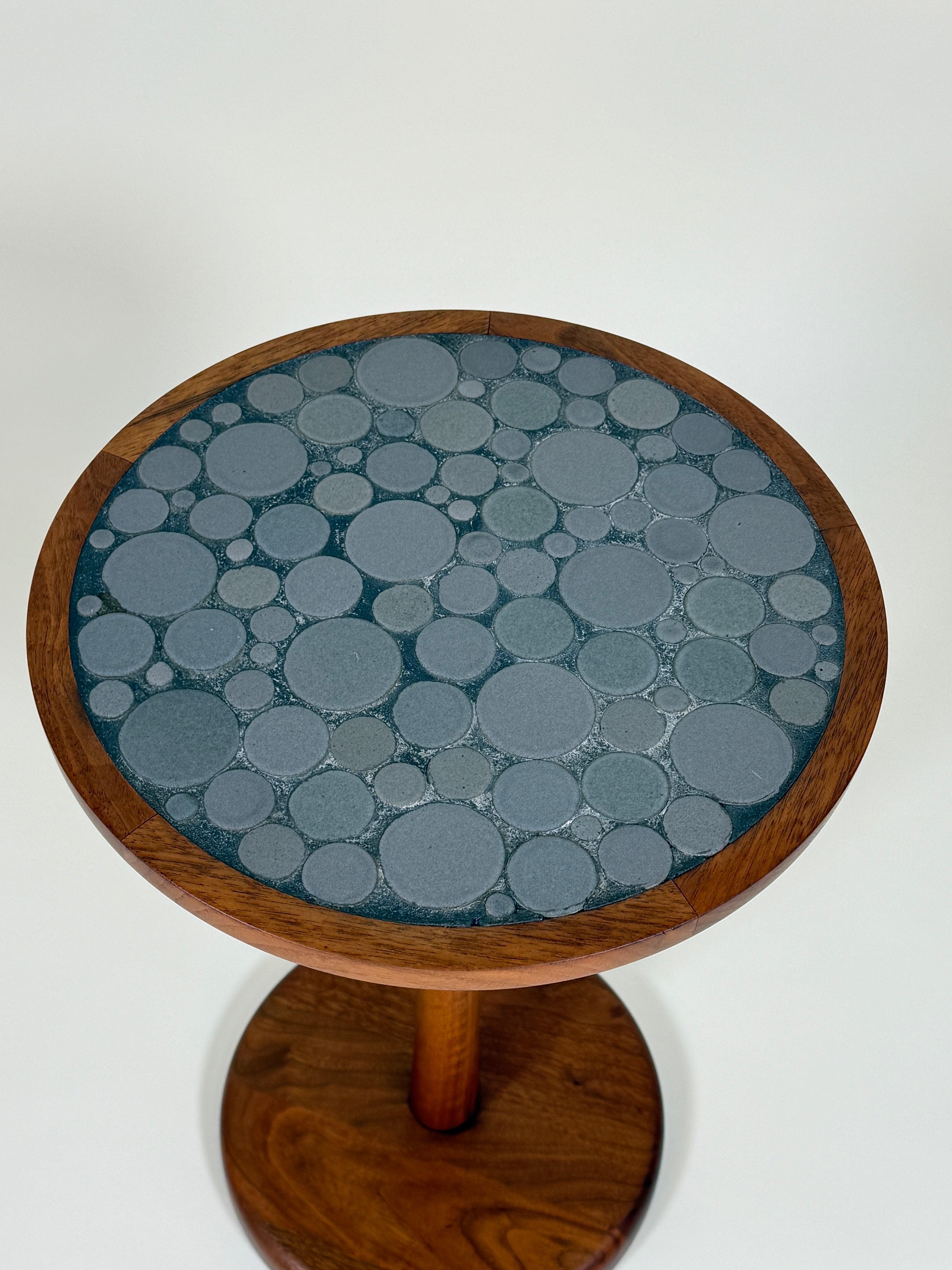 Gordon & Jane Martz Gray Coin Tile Mosaic Side Table

A highly collectible  stunning example of mid-century ceramic artistry, this Gordon & Jane Martz side table features a beautifully crafted gray coin tile mosaic top—a signature design element of