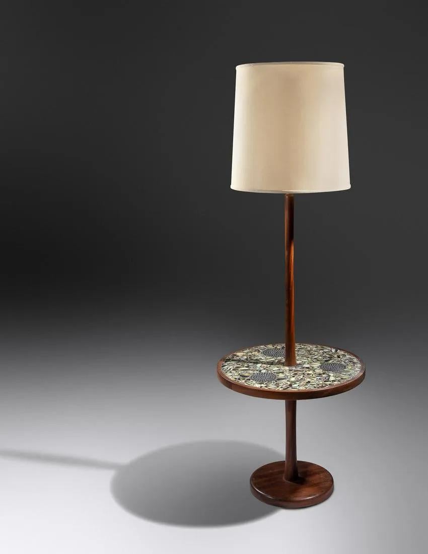An elegant Mid-Century Modern floor table lamp by designers Gordon and Jane Martz (American, 1924-2015 / /American, 1929-2007). The floor lamp is hand carved of walnut and is a chic combination of form and function. The floor lamp features a round