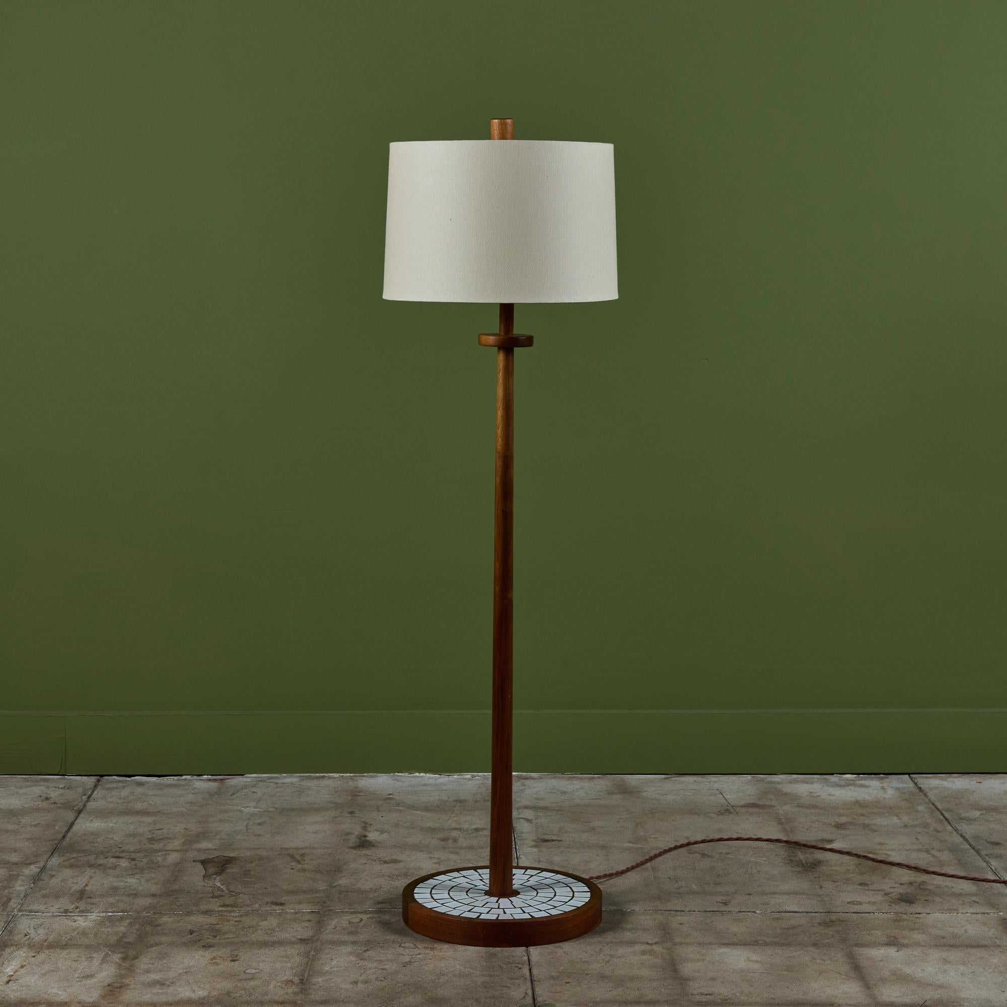 Gordon & Jane Martz floor lamp with mosaic tile round base. This piece features a walnut stem and base with inlaid square white ceramic tiles. The lamp has a new linen shade and has been professionally rewired.
 
Dimensions
16