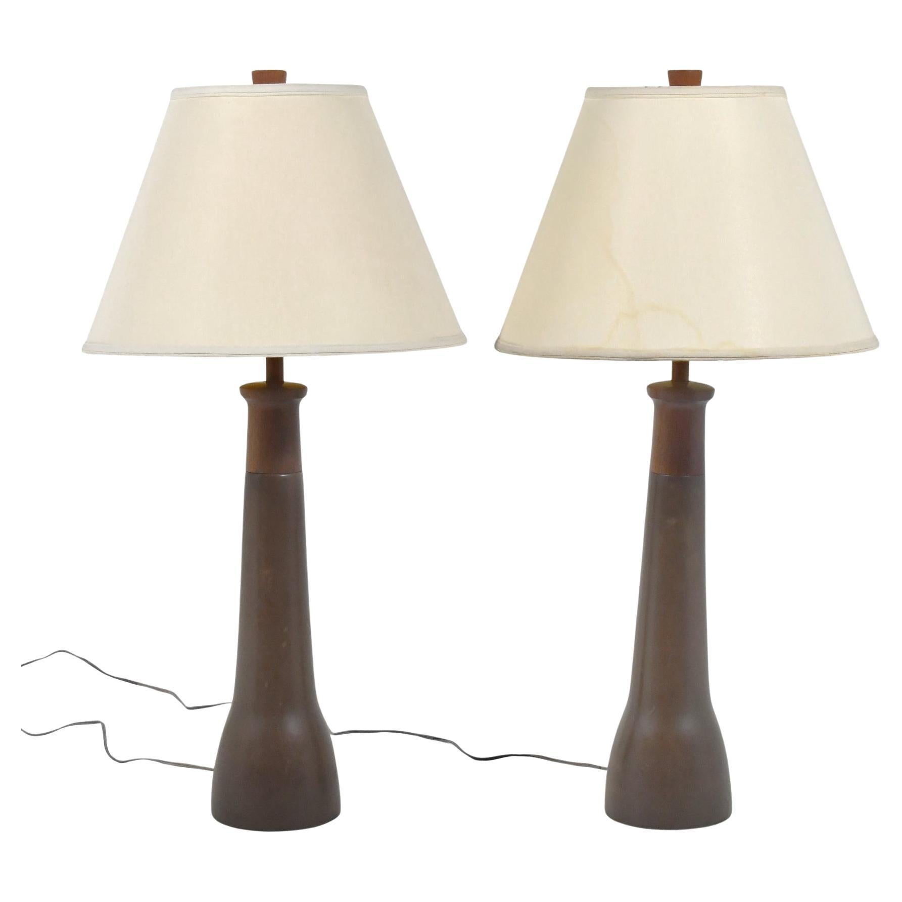 The lamps by Gordon and Jane Martz are noteworthy for their subtle shaped and refined forms with elegant glazes and detailing. This pair of matched lamps are model 165-30 with a dark brown satin glaze (165 denoting the base design and 30 the glaze).