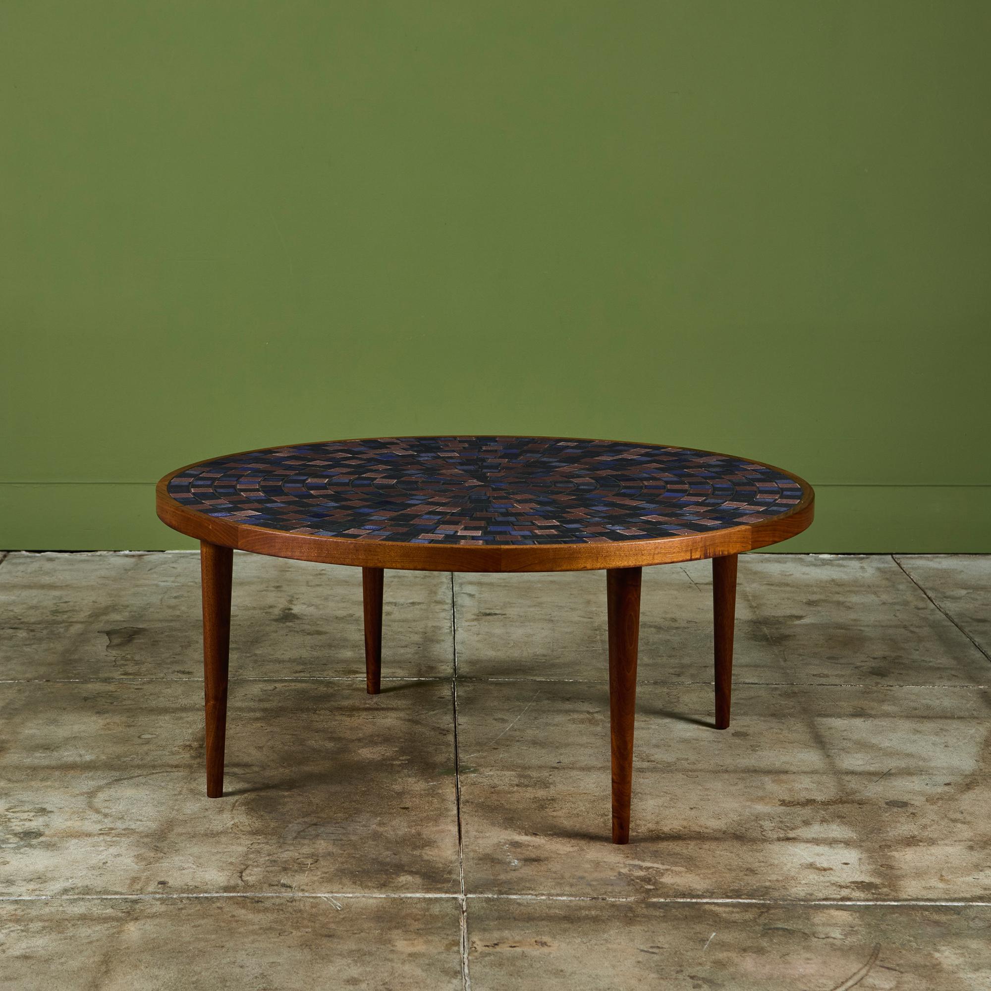 Tavolino rotondo di Gordon & Jane Martz per Marshall Studios, anni '60 circa, USA. Il piano del tavolo è intarsiato con piastrelle quadrate e triangolari in ceramica smaltata blu, marrone e marrone in un motivo geometrico. La struttura e le quattro