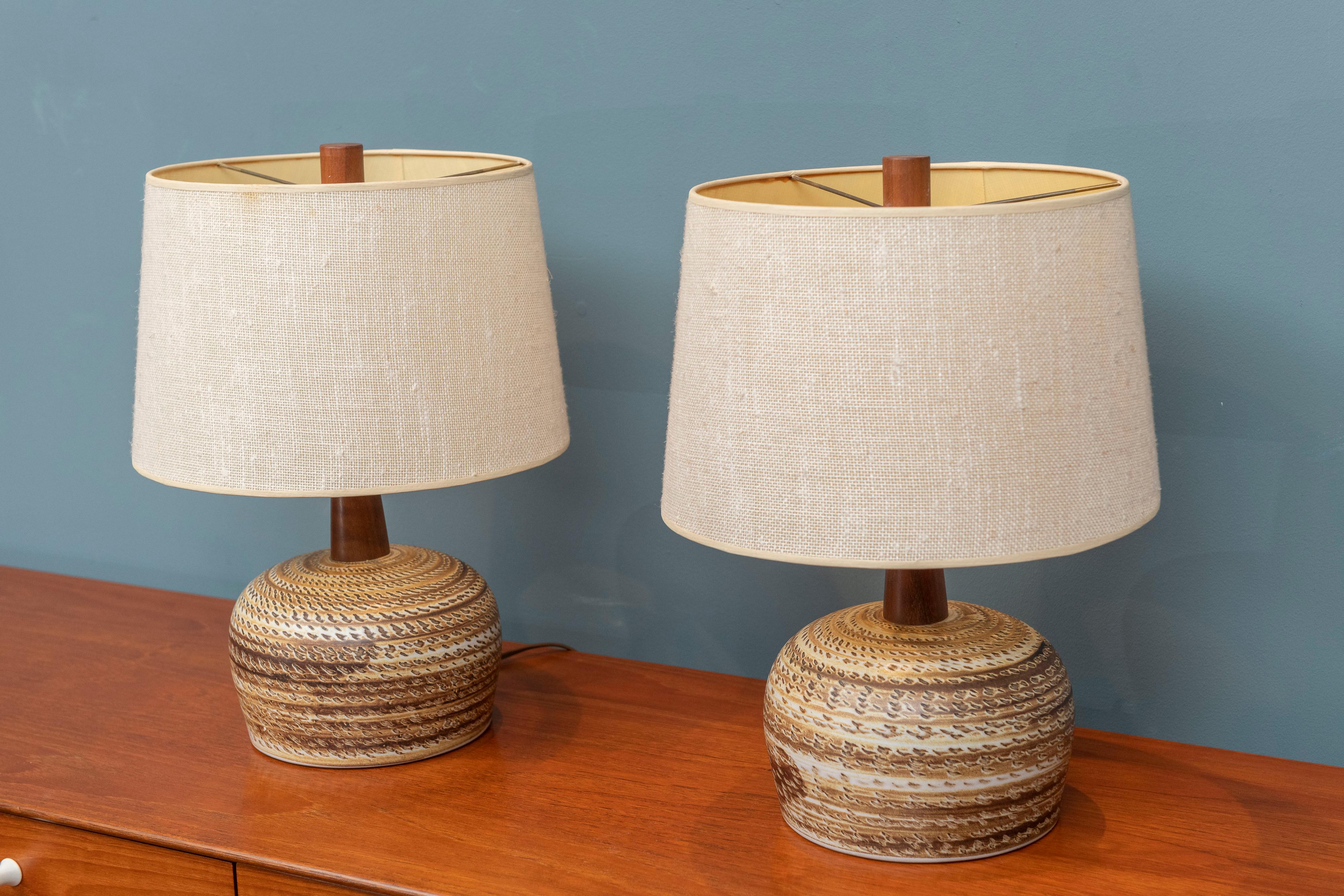 Gordon & Jane Martz design table lamps for Marshall Studios. Made with an artistic dome form ceramic body, teak necks, original shades and finials. Signed on the lower rear and ready to install.