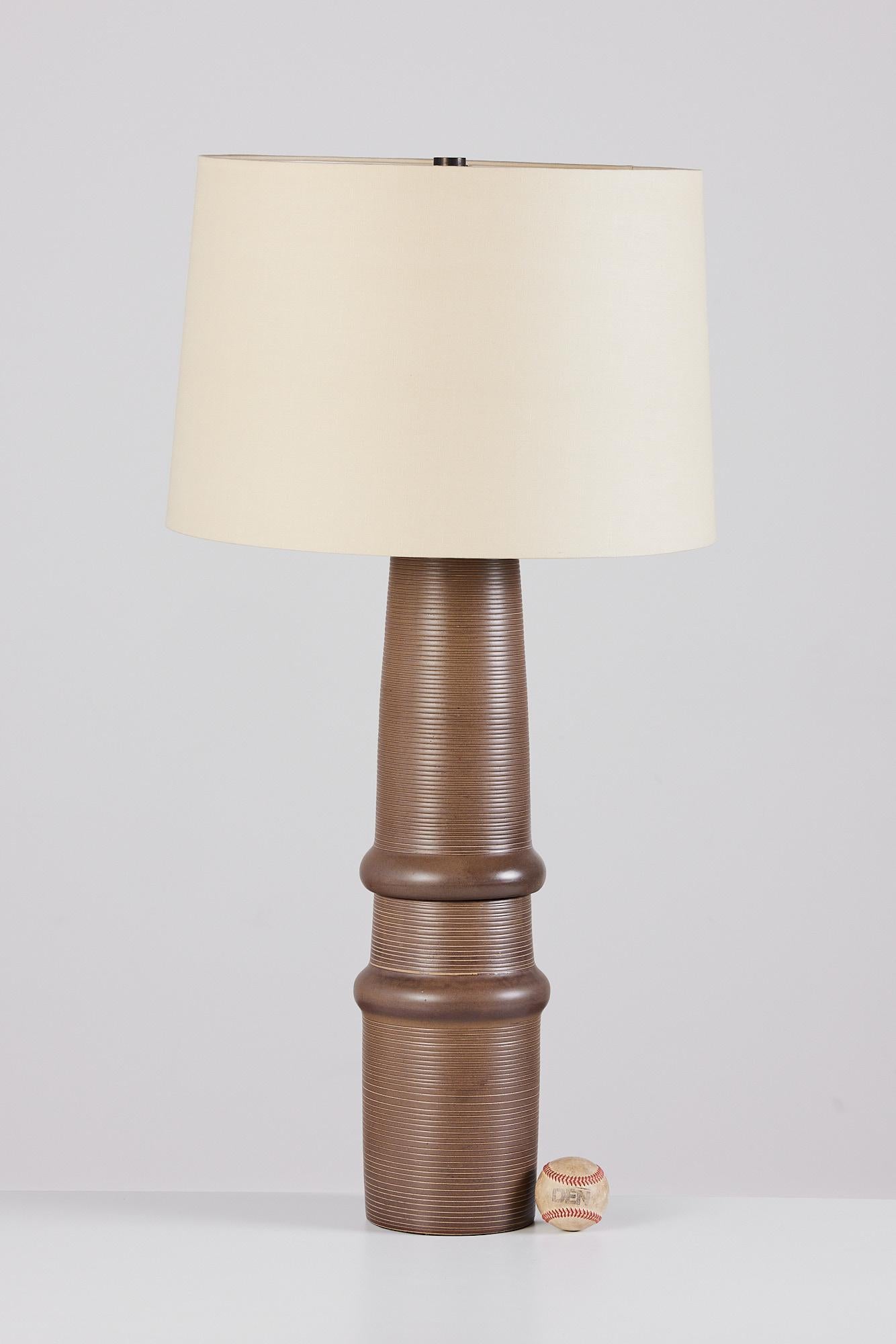 A tall and striking ceramic lamp by husband-and-wife design team Gordon and Jane Martz. Produced by their family company, Marshall Studios in Indiana beginning in 1957. The Model 172 lamp has an organic form with a ribbed texture produced by