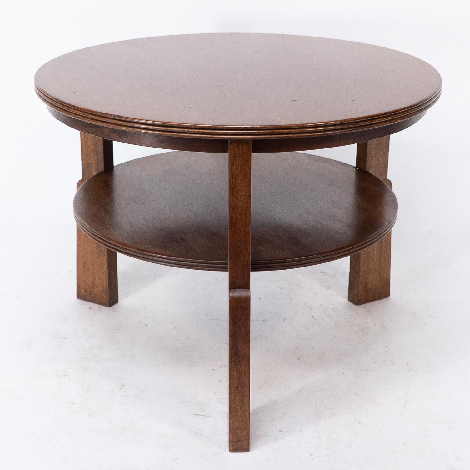 Gordon Russell, a Gunstock figured walnut circular coffee table with under tier, on three gunstock shaped legs.
Original Broadway label.