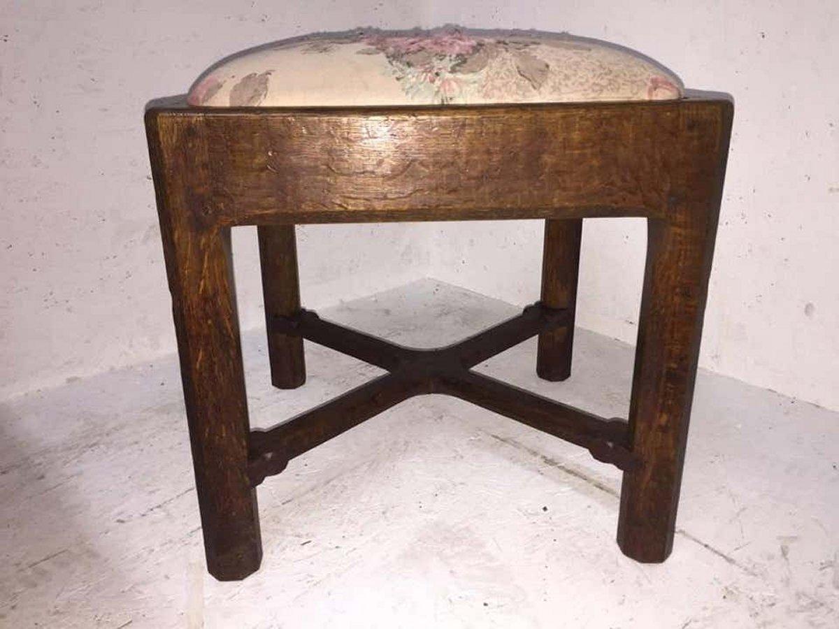 Arts and Crafts Gordon Russell, an Arts & Crafts Cotswold Oak Stool with Carved Cross Stretcher