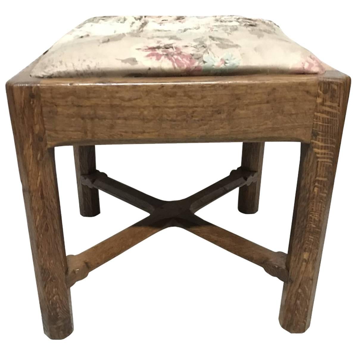 Gordon Russell, an Arts & Crafts Cotswold Oak Stool with Carved Cross Stretcher
