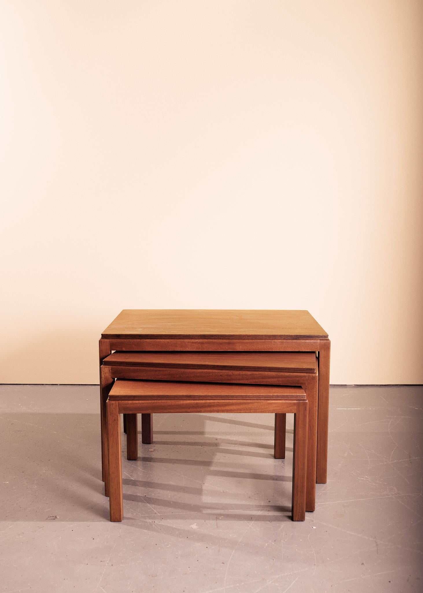 A nest of three walnut tables by Gordon Russell. Simple in form with an inset, reeded edge and rounded legs. Minimal restoration, just a light polish, these tables are in excellent condition, with makers plate label ‘Gordon Russell Limited, Broadway