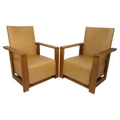 Antique Gordon Russell, W. H. Russell. A pair of Arts & Crafts oak reclining armchairs