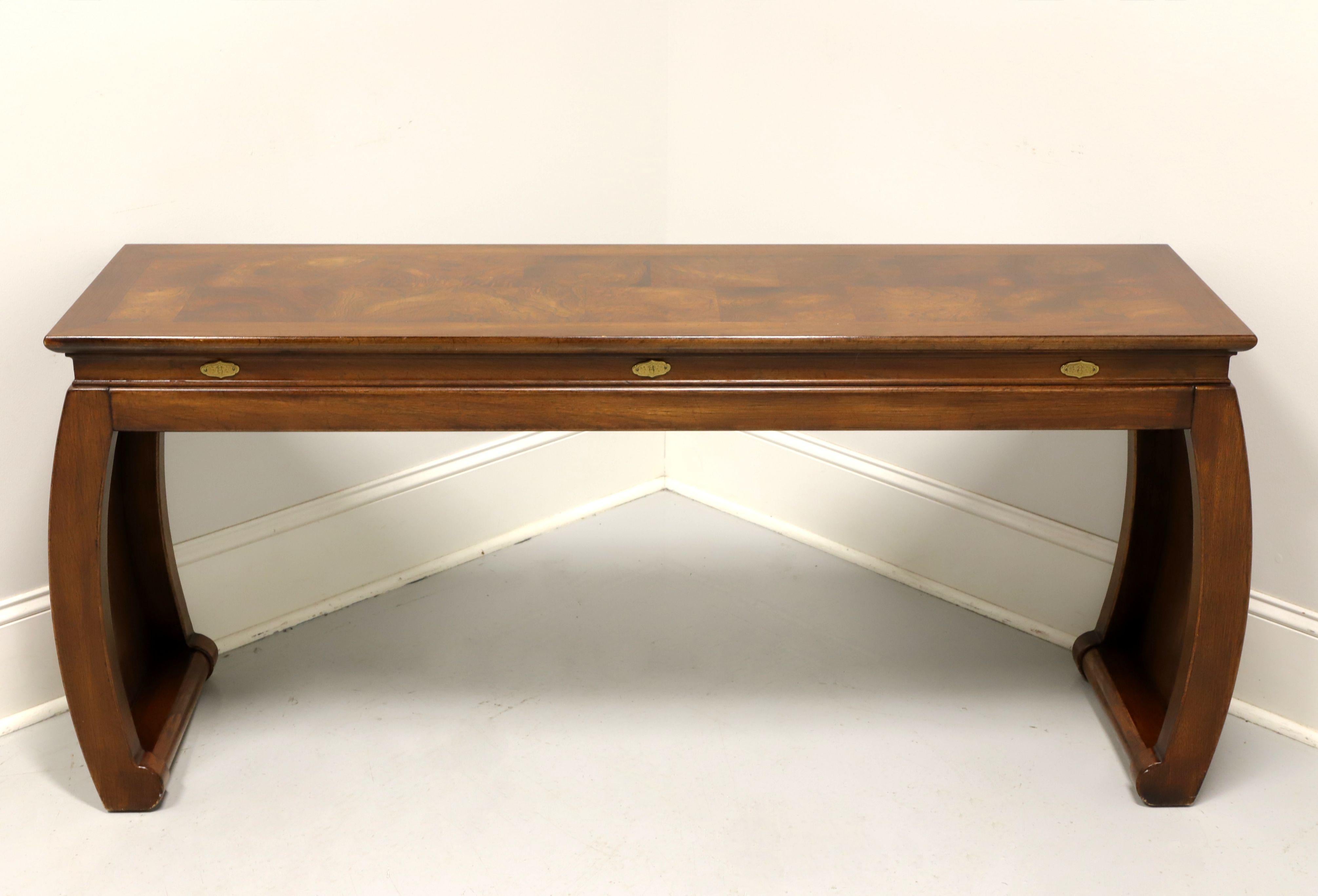 An Asian style sofa table by Gordon's Furniture, of Johnson City, Tennessee, USA. Fruitwood with a banded inlaid burlwood parquetry design to the top, brass escutcheon accents to apron, and solid scroll legs. Made in the late 20th