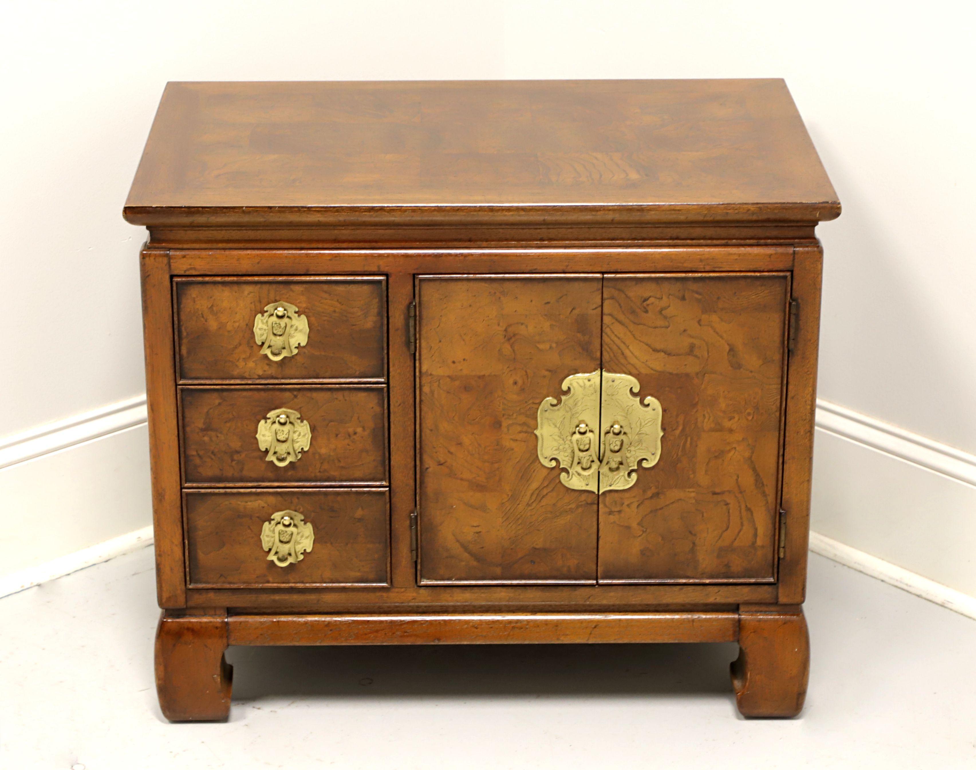 An Asian style nightstand by Gordon's Furniture, of Johnson City, Tennessee, USA. Fruitwood with a banded inlaid burlwood parquetry design to the top, burlwood to door & drawer fronts, brass hardware and scroll legs. Features three small drawers of