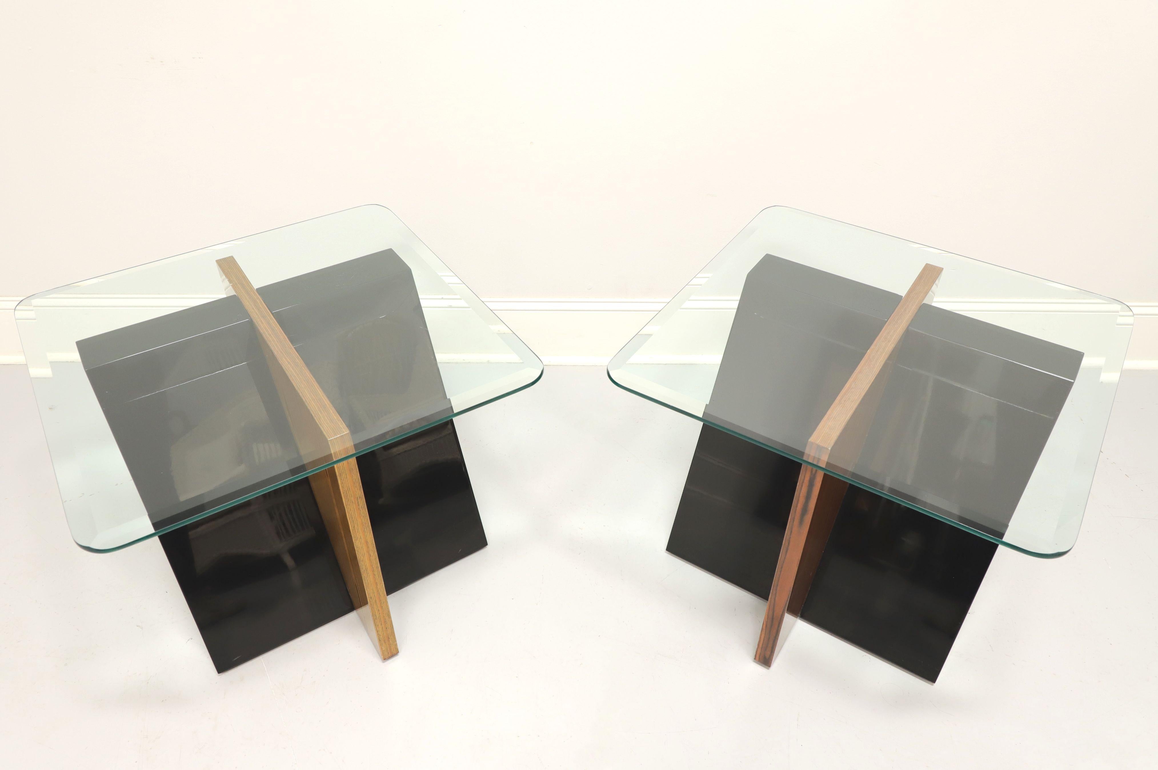A pair of Contemporary glass top end tables by Gordon's Furniture, of Johnson City, Tennessee, USA. Acrylic and hardwood base in a slanted crossed 