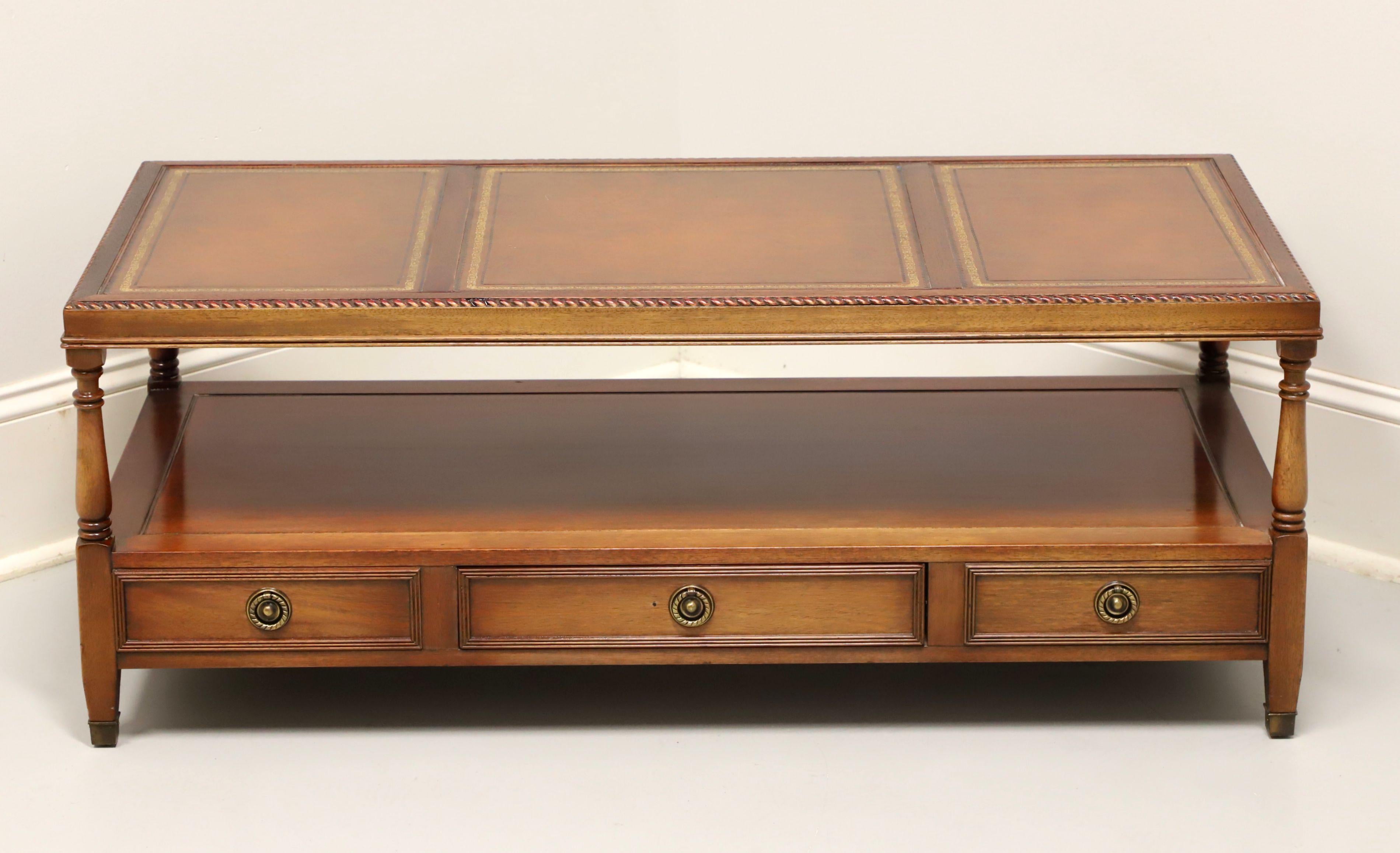 A Federal style rectangular coffee table by Gordon's Furniture, of Johnson City, Tennessee, USA. Mahogany with brass hardware, three panel inlaid embossed leather top, gadroon edge, turned corner posts, an undertier shelf with drawer and brass toe