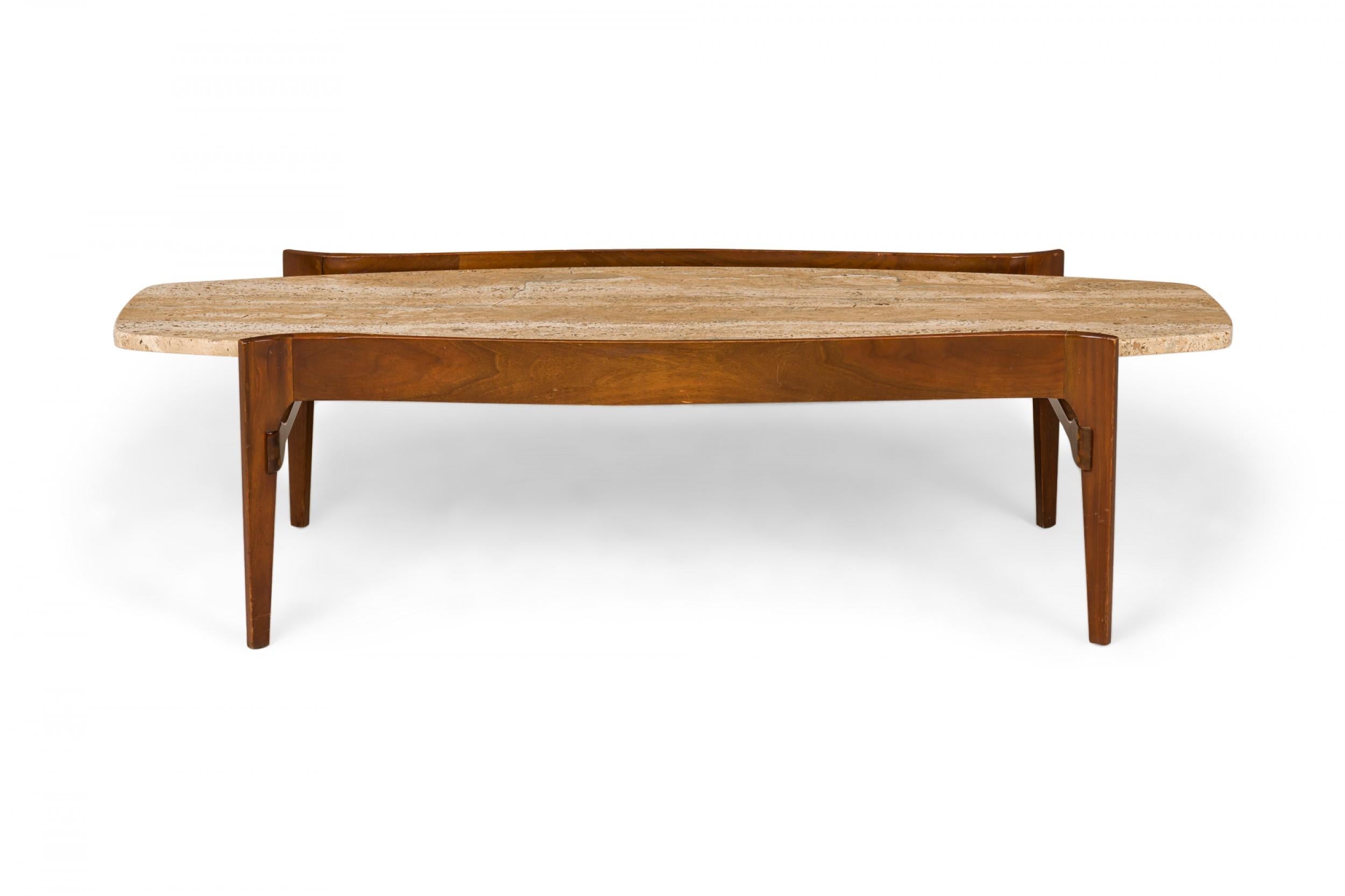 American Mid-Century coffee / cocktail table with a shaped walnut frame supporting a surfboard-shaped travertine tabletop. (GORDONS OF TENNESSEE)(Companion end tables: DUF0387)