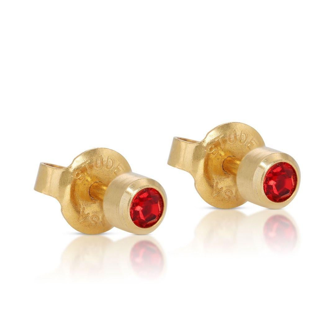 Introducing our exquisite 22K Yellow Gold Ruby Earrings, a timeless expression of elegance and sophistication. Each earring features a dazzling round brilliant ruby stone, totaling 0.20 carats. These captivating gemstones exhibit a rich, vibrant red