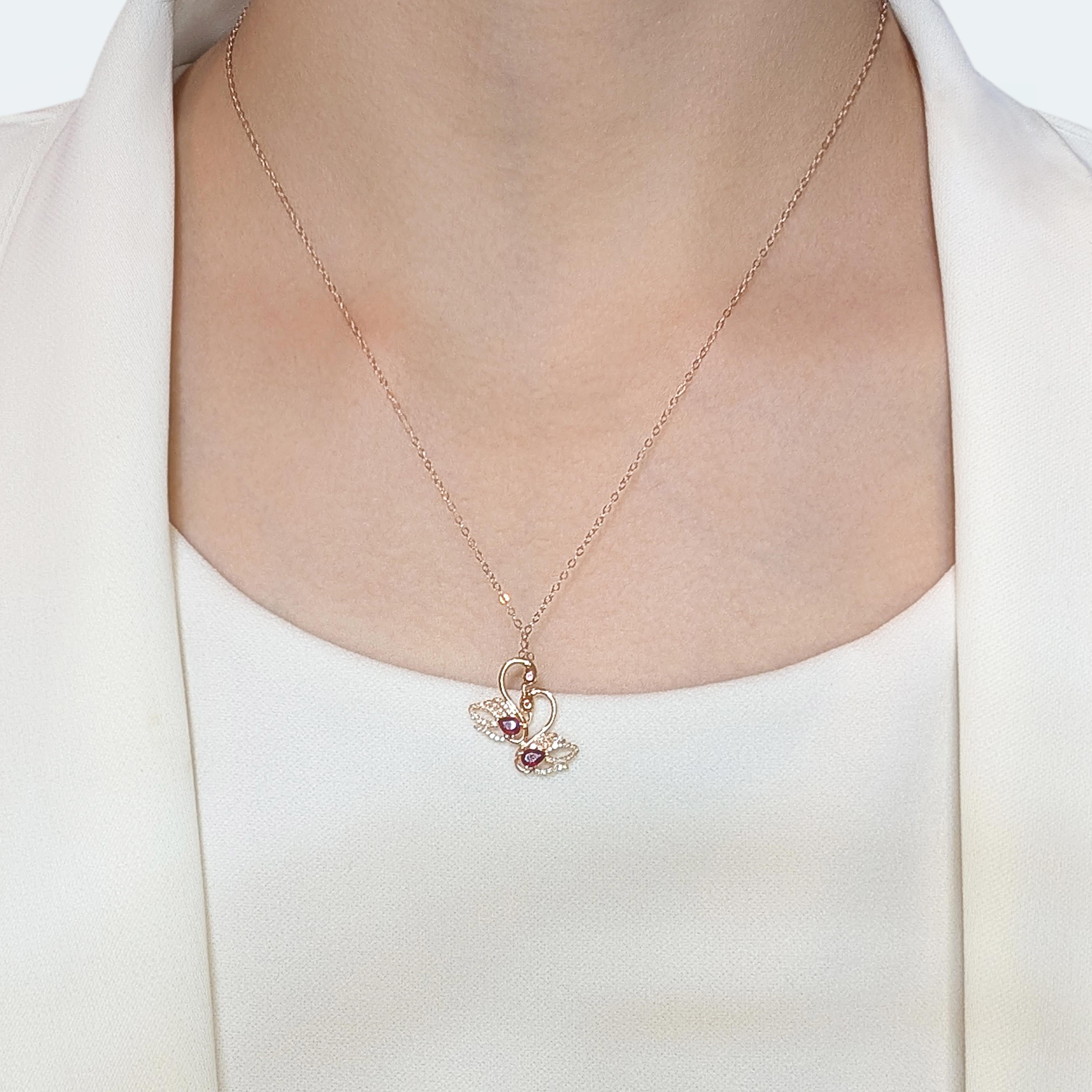 This captivating pendant, crafted in luxurious 18K rose gold, exudes timeless elegance and charm. Showcasing 2 pear-shaped rubies and 2 round brilliant-cut rubies with a combined weight of 0.26ct, the rich red hues create an eye-catching