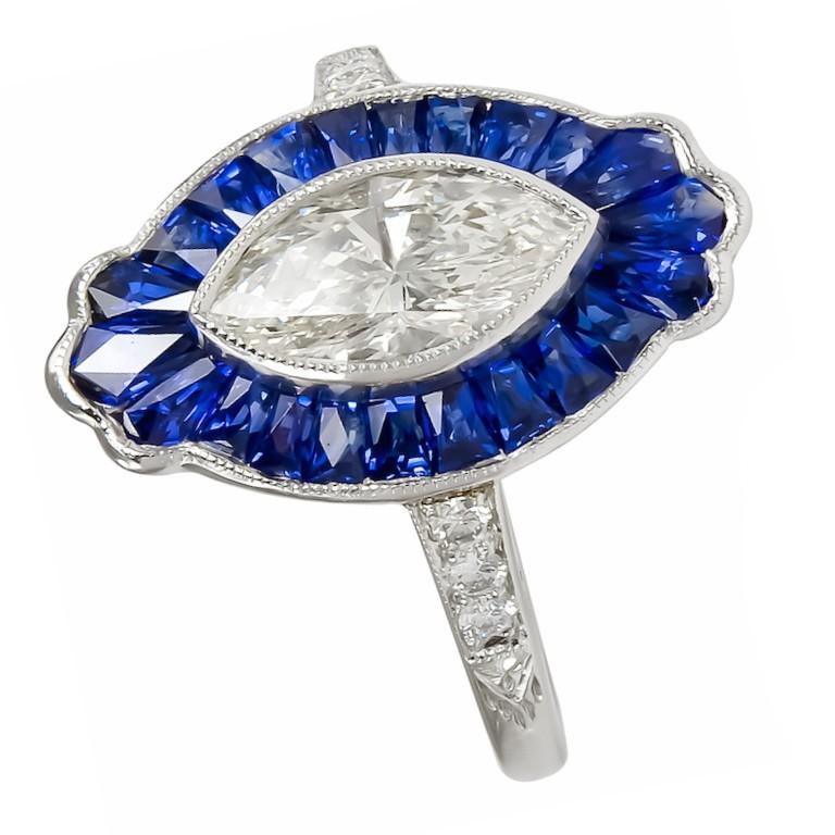 This elegant ring has center marquise cut diamond with the total carat weight of 0.95 together with stunning sapphire with the carat weight of 2.58 surrounded with brilliant diamonds with the total carat weight of 0.9. 

Sophia D by Joseph Dardashti