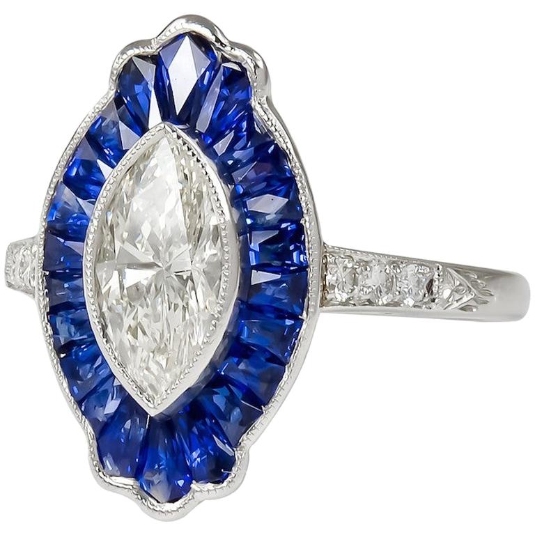 Sophia D. 0.95 Carat Marquise Cut Center Diamond and Blue Sapphire Platinum Ring For Sale