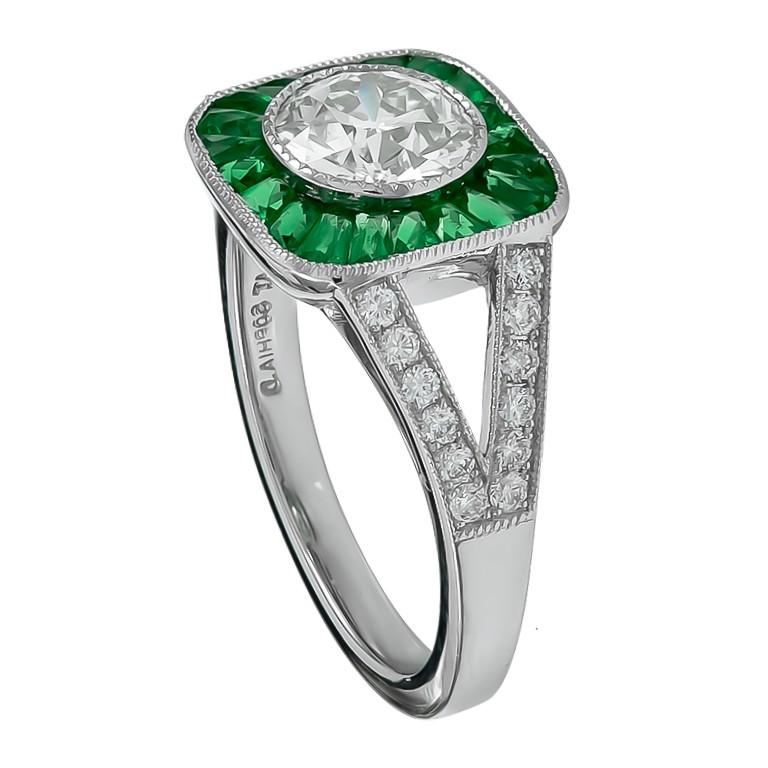 This elegant ring showcases the stunning center round diamond with the total carat of 1.08 surrounded with emerald stones that gives overall beauty and brilliance with the total carat weight of 0.55 and stunning brilliant diamonds with the total